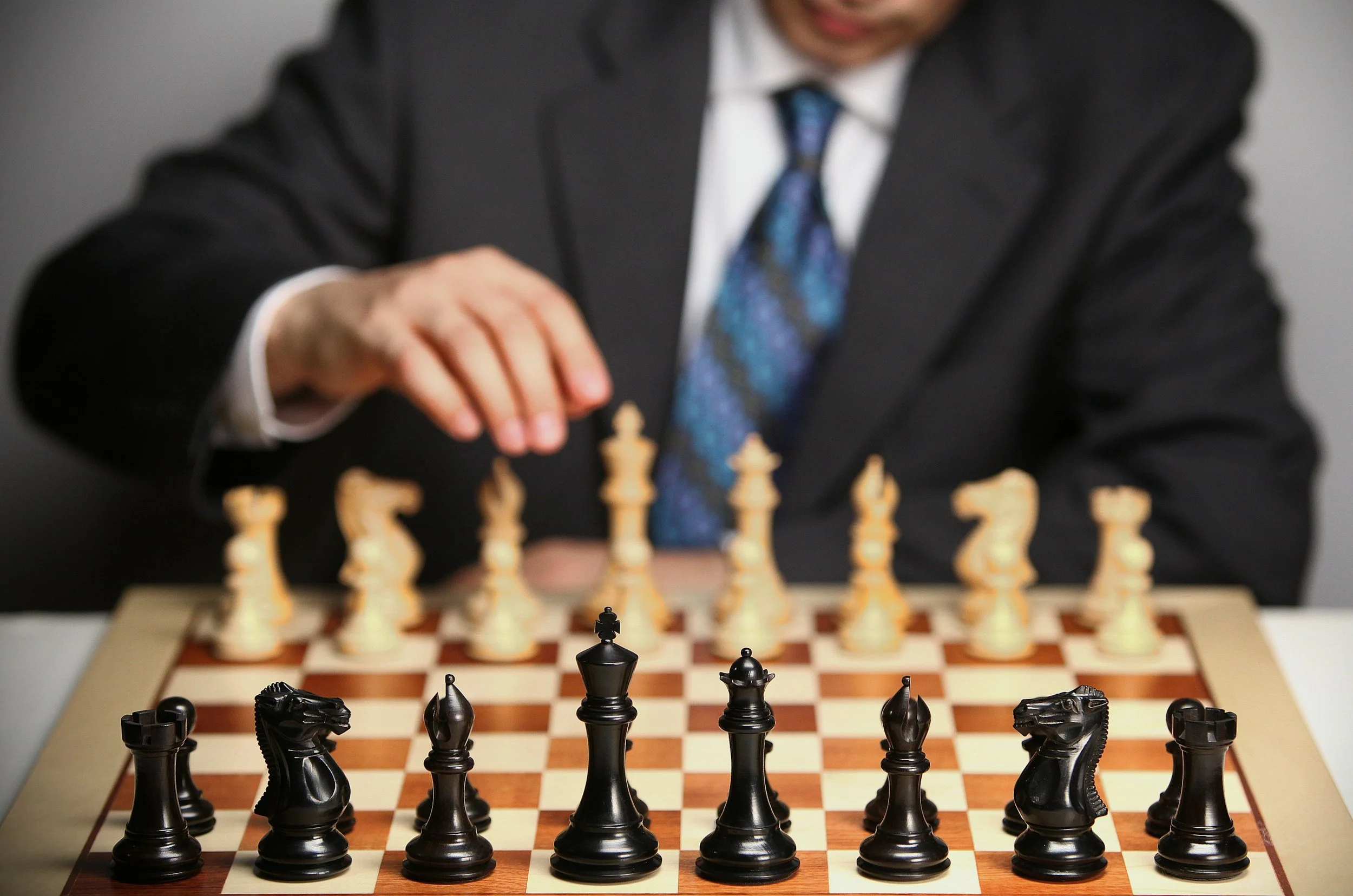 Business professional playing chess representing Maverick HQ's strategic marketing planning and brand audit services.