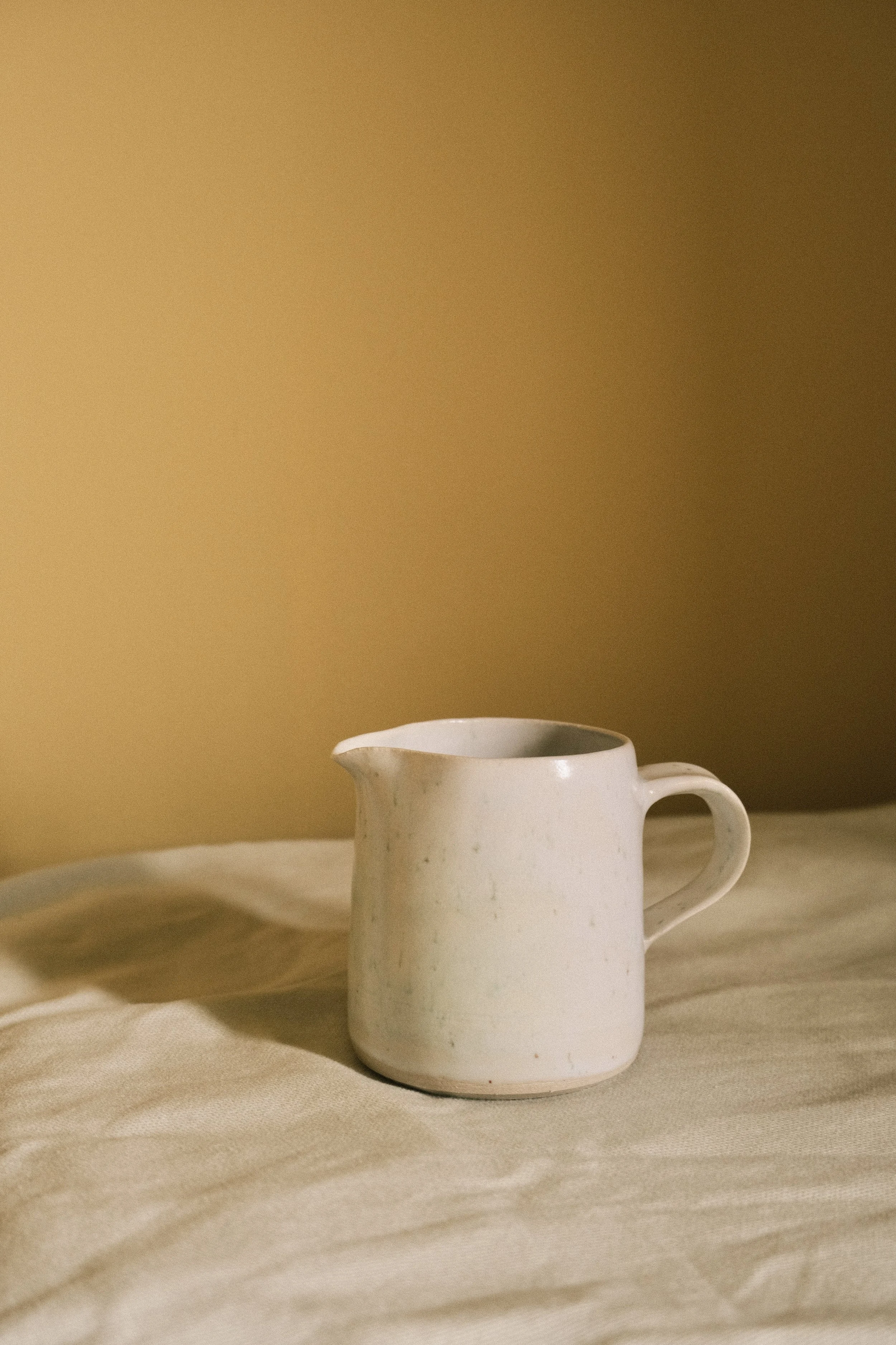 Specked white milk jug