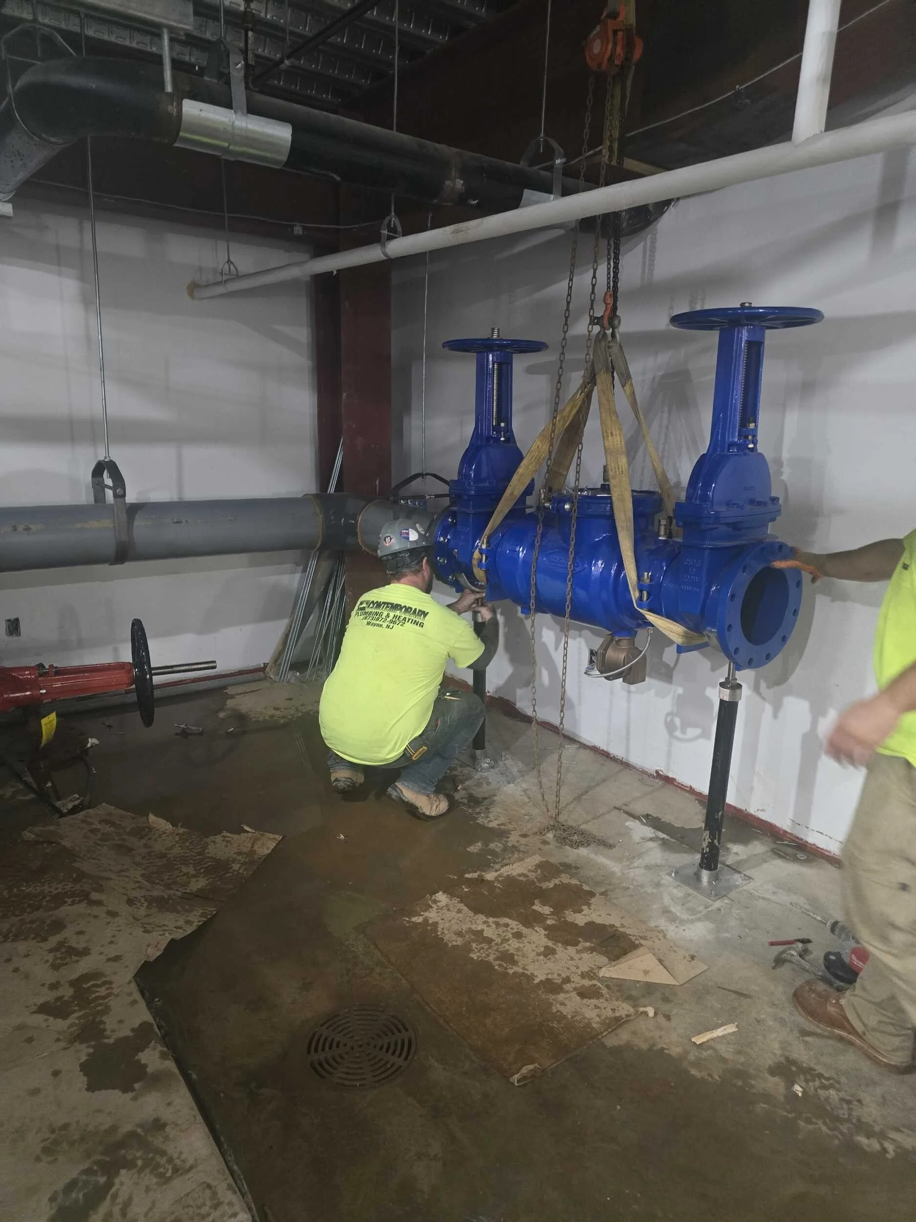 Photo of a Contemporary employee doing a Backflow Prevention install.