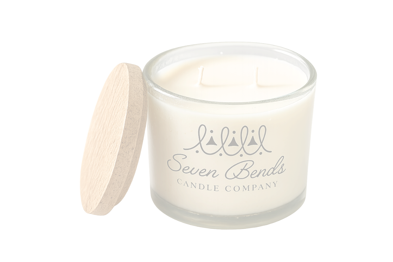 A cream-colored candle in a glass jar with a wooden lid, labeled 'Seven Bends Candle Company' and featuring a simple crown logo.