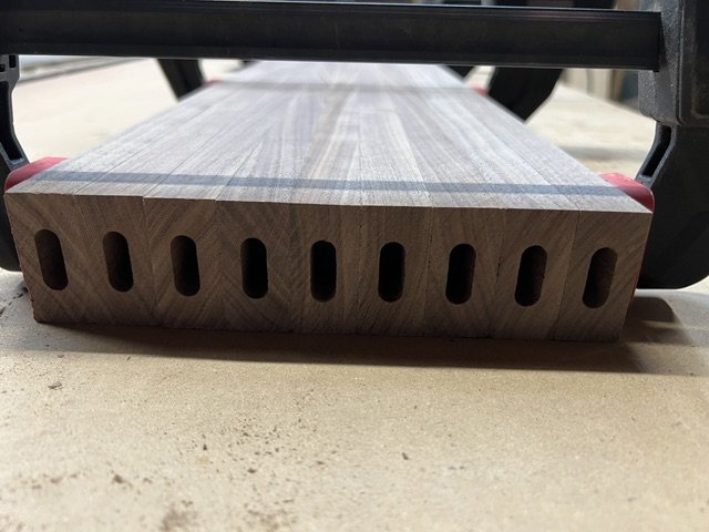 End view of walnut slats for entryway table showing joinery.