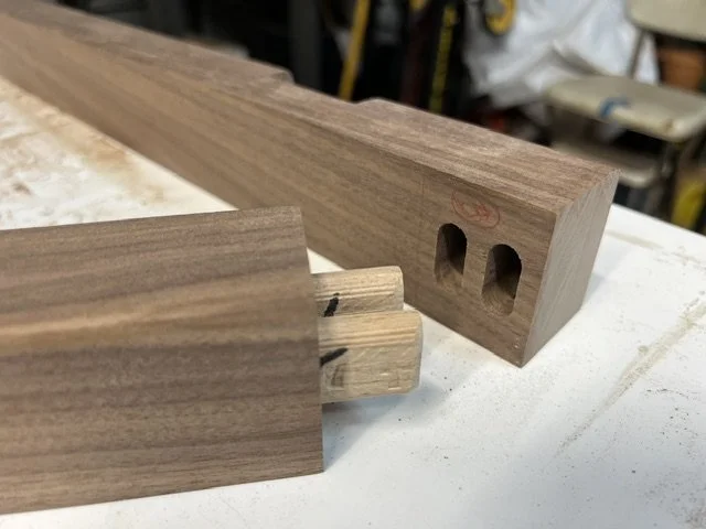 Showing the loose tenon joint of two walnut pieces.