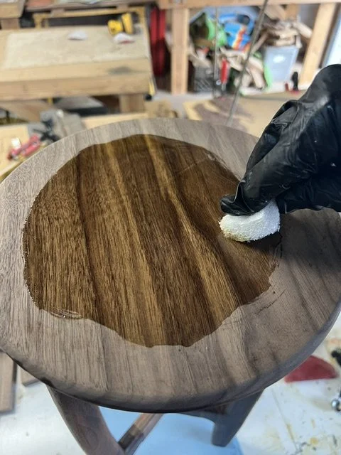 Hard wax oil finish applied to round walnut table top.