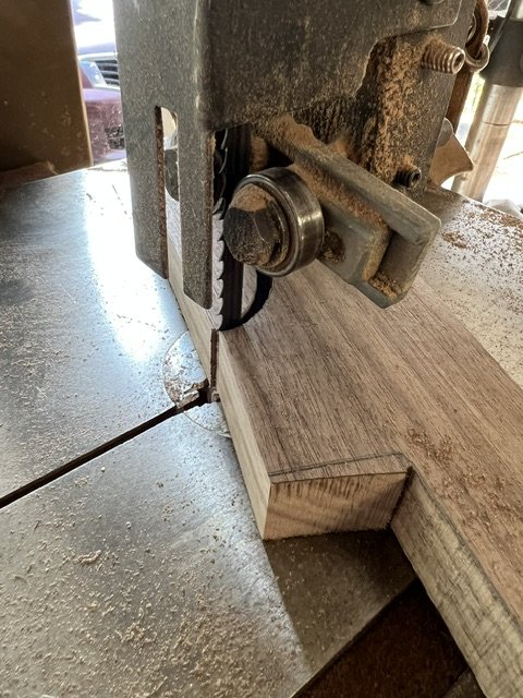 Bandsaw cutting a curve in walnut.
