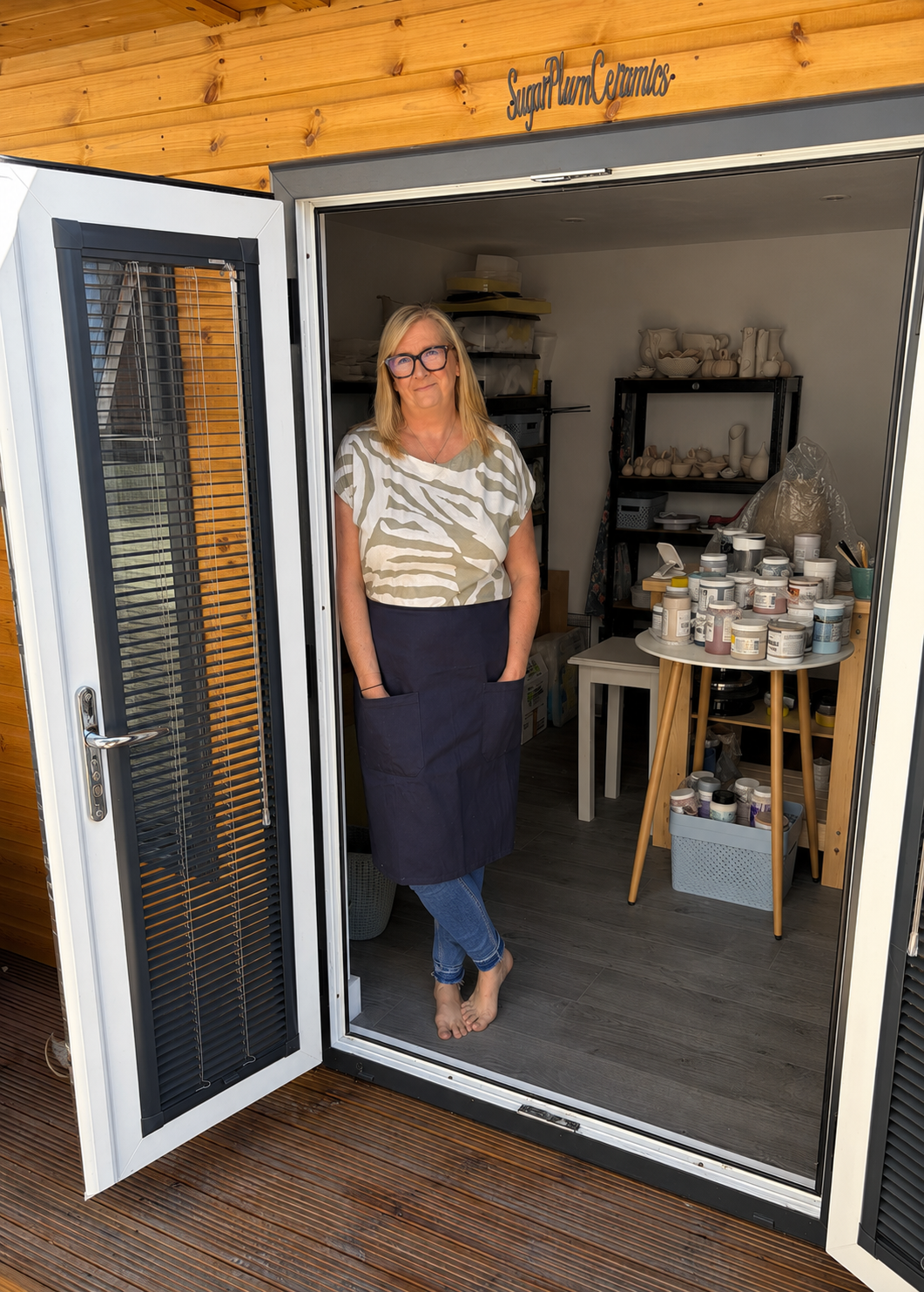 Potter standing inside the SugarPlum Ceramics garden studio in Doncaster.