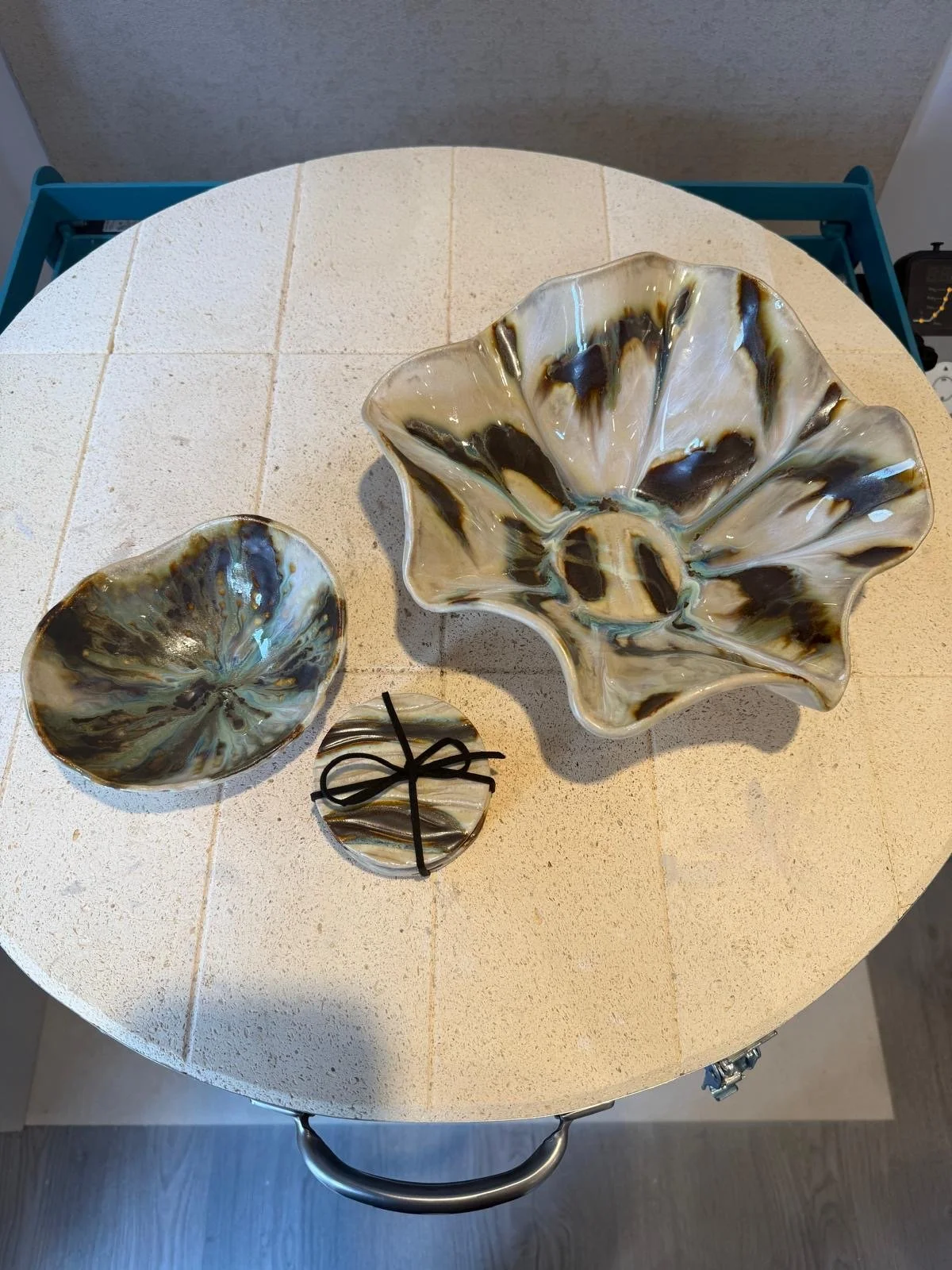 Handcrafted ceramic pieces displayed on a worktable in the pottery studio.