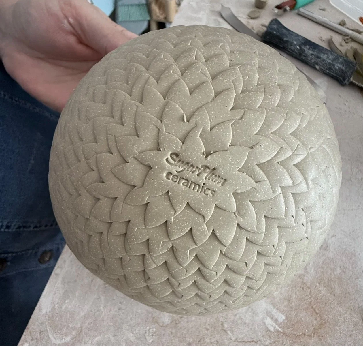 SugarPlum Ceramics maker’s mark impressed into the base of a handmade ceramic piece.