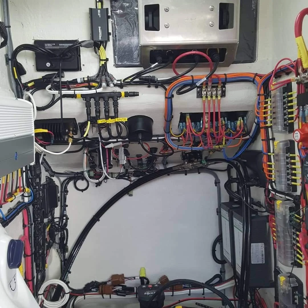 Precision marine wiring installation featuring labeled circuits, organized cable routing, and professional electrical integration.