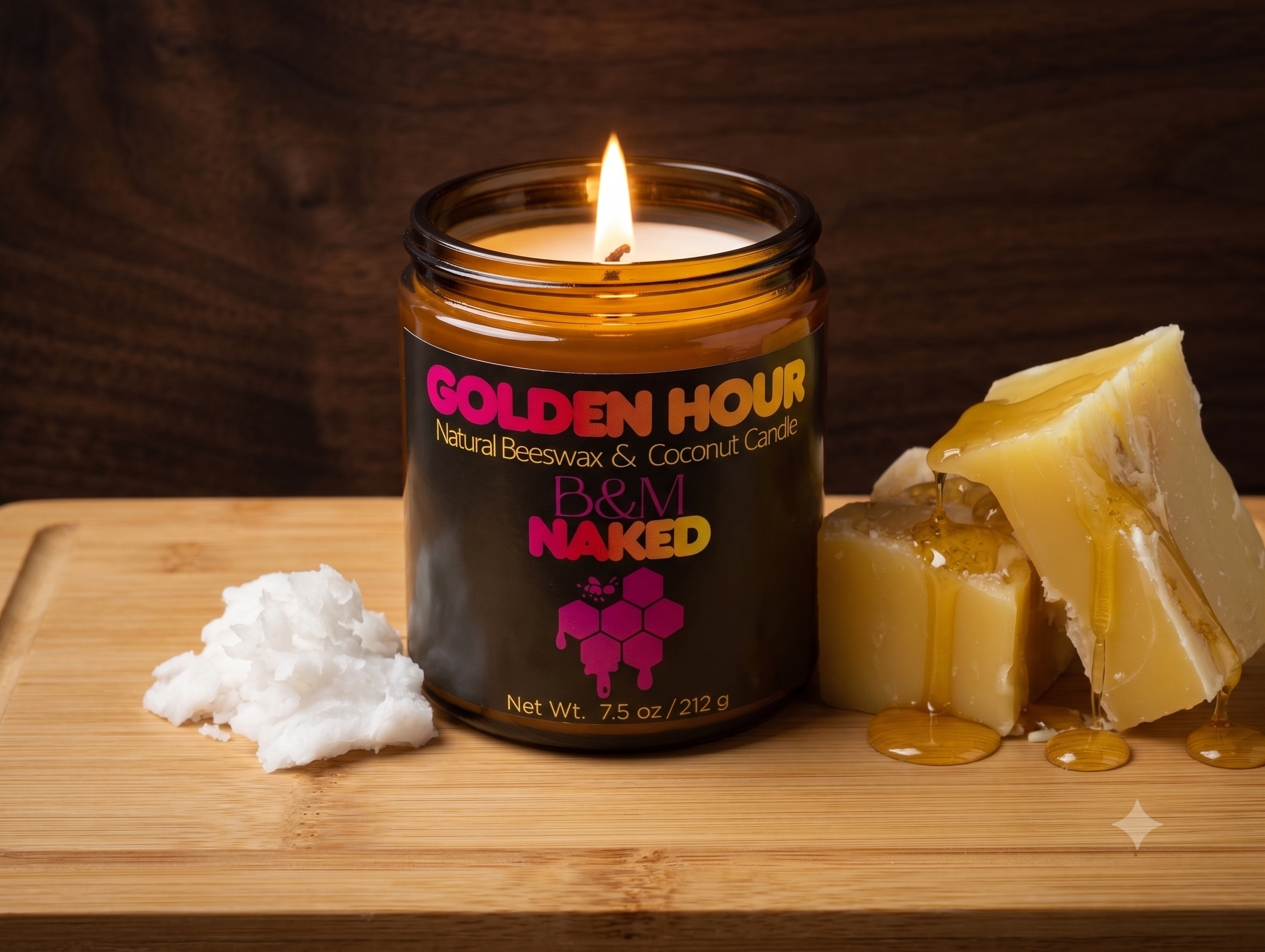 A lit candle with a black label reading "GOLDEN HOUR Natural Beeswax & Coconut Candle" on a wooden surface, with chunks of beeswax and a dollop of white beeswax in the foreground, and a slice of beeswax in honey dripping onto the surface, against a d