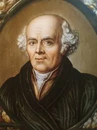 Portrait of an elderly man with white curly hair, wearing a dark robe and white shirt, against a brown background.