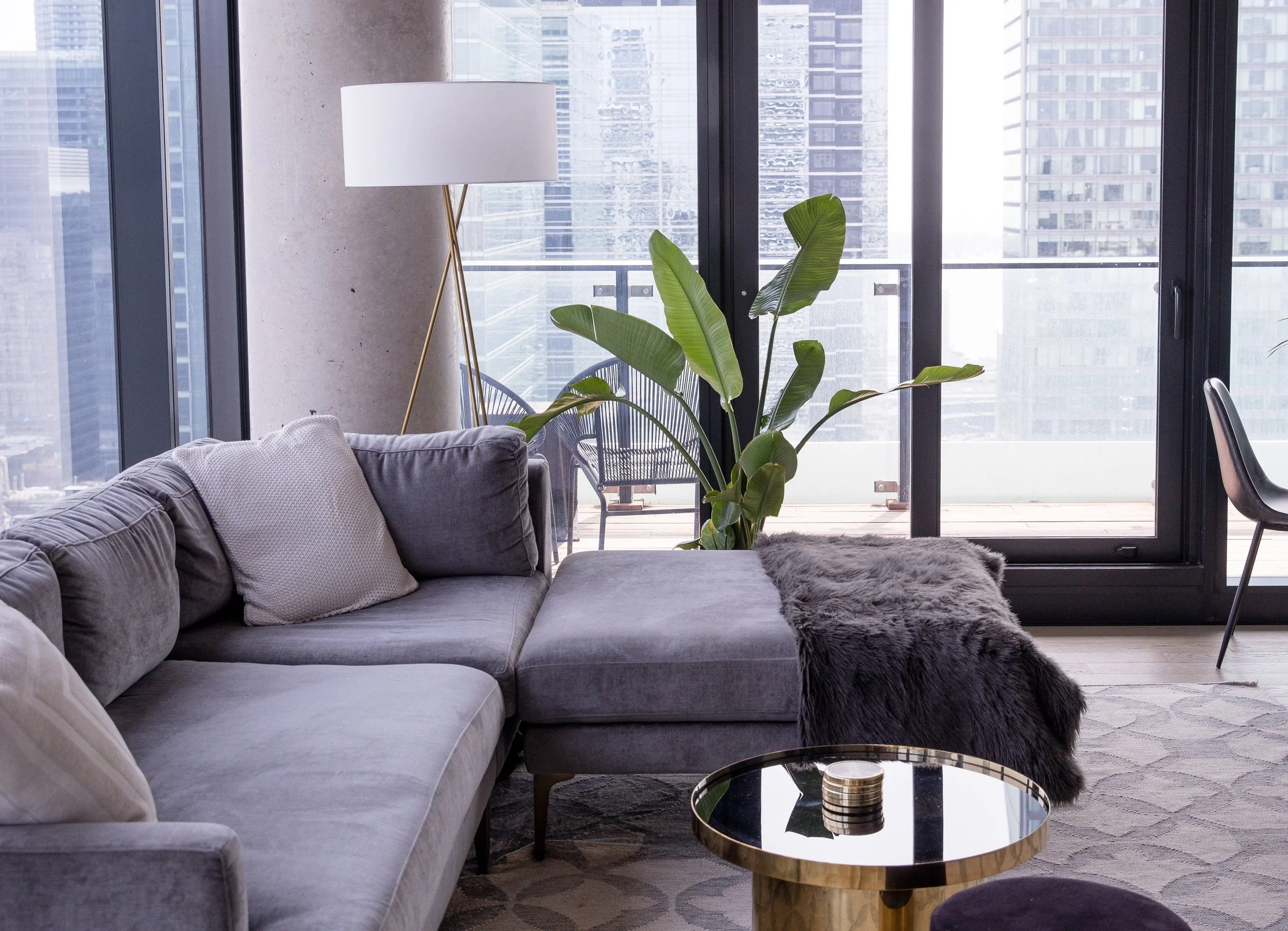 New condo home with a modern living room with a view. The furniture is in scale with the room and fully accessible.