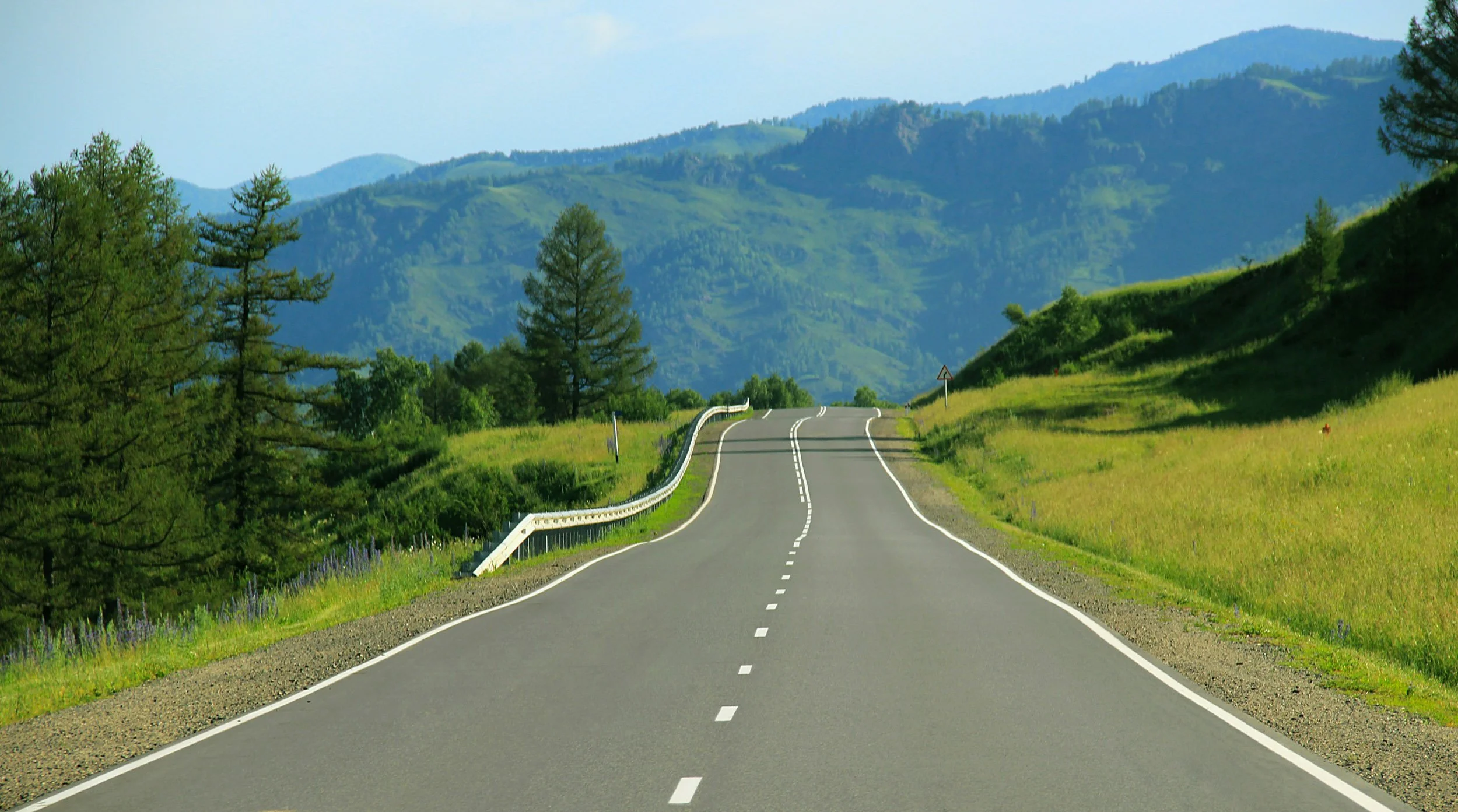 two lane road through mountainous foothills