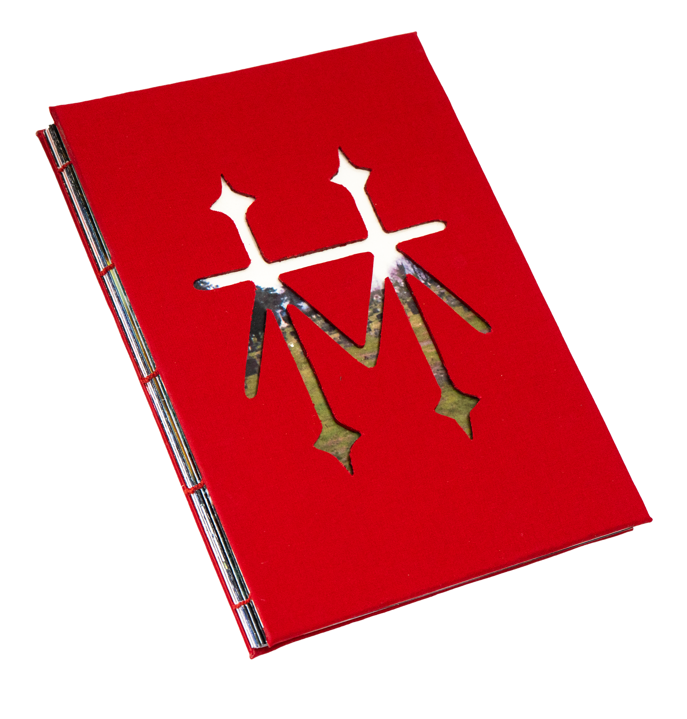 Red booklet with cut-out star designs revealing colorful photographs underneath.