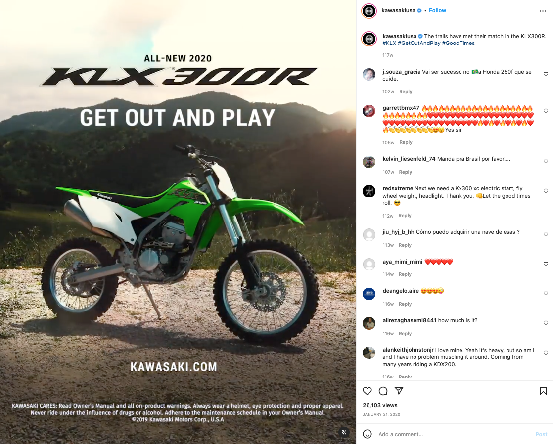 Green and white off-road Kawasaki dirt bike parked on dirt ground with a mountain landscape background. Text over the image promotes the 2020 Kawasaki KLX 300R motorcycle and an outdoor riding message.