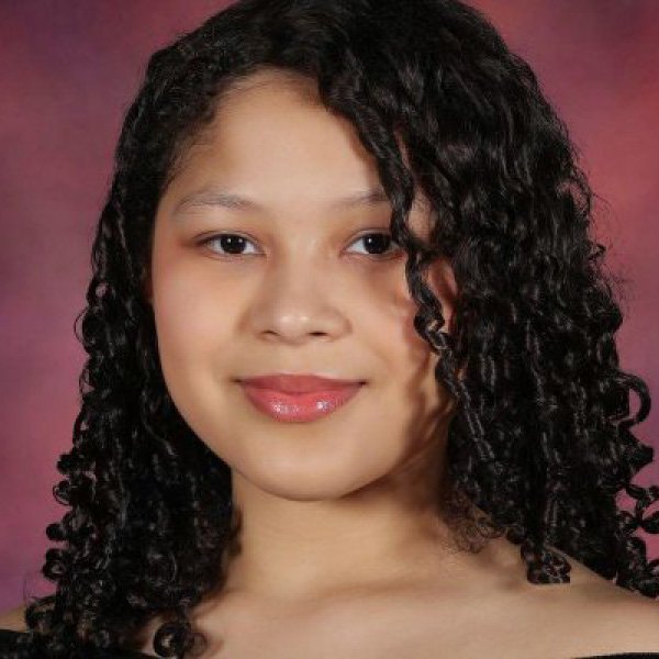 Young woman with brown curly hair