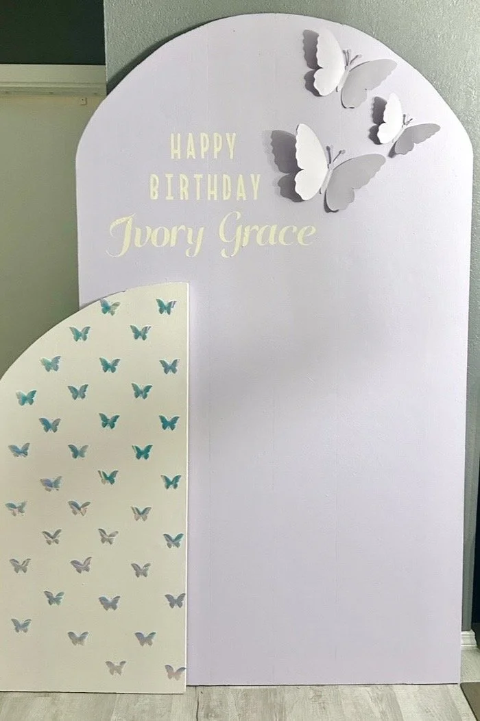 Birthday display board with white butterflies and text saying "Happy Birthday Ivory Grace".