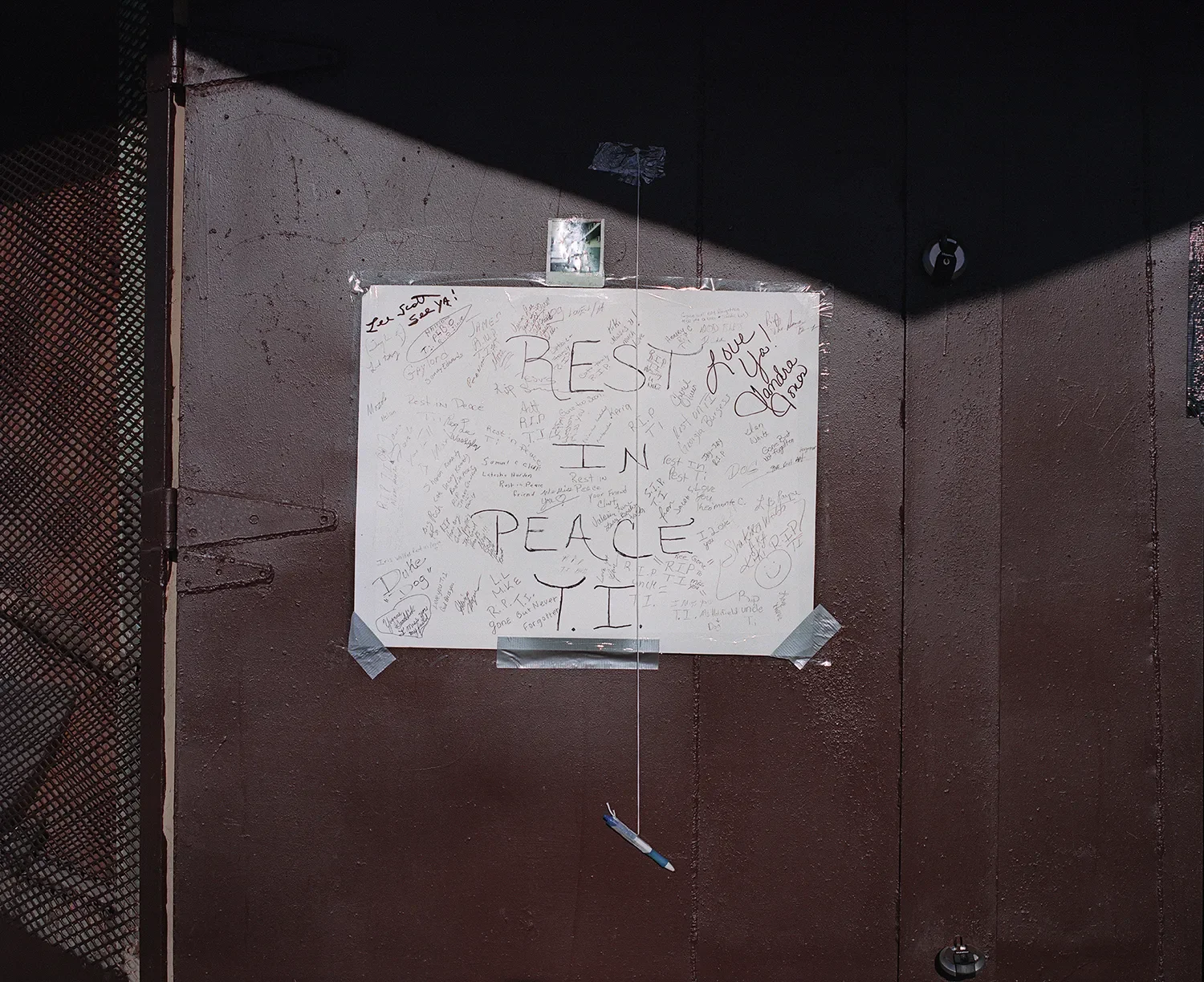 After T.I., a local resident that oversaw a laundry mat in downtown Belle Glade, passed away, this makeshift memorial was placed on the doors of the laundry mat to commemorate him.