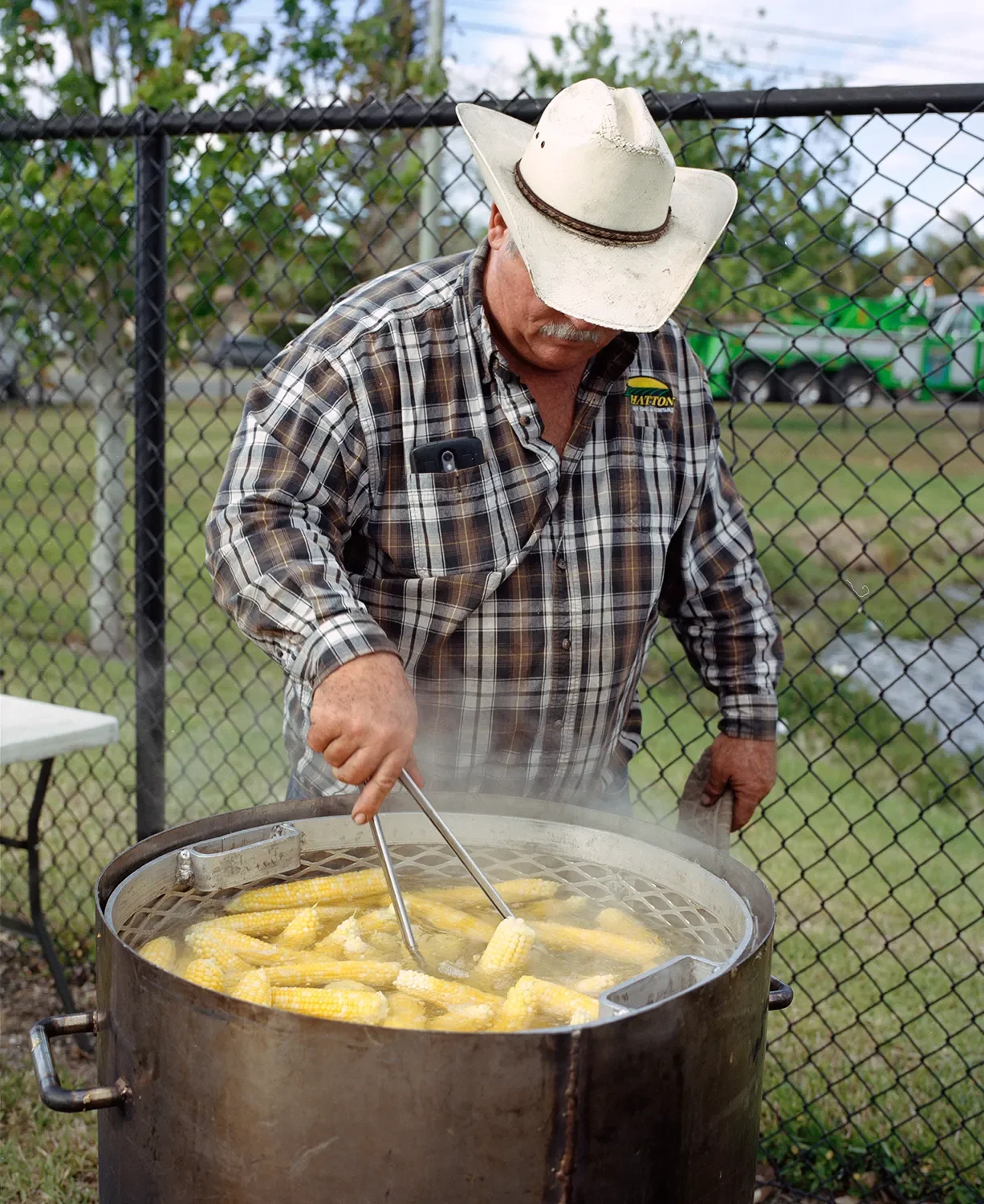 A local farmer cooks and gives away corn during an event for local politicians.
