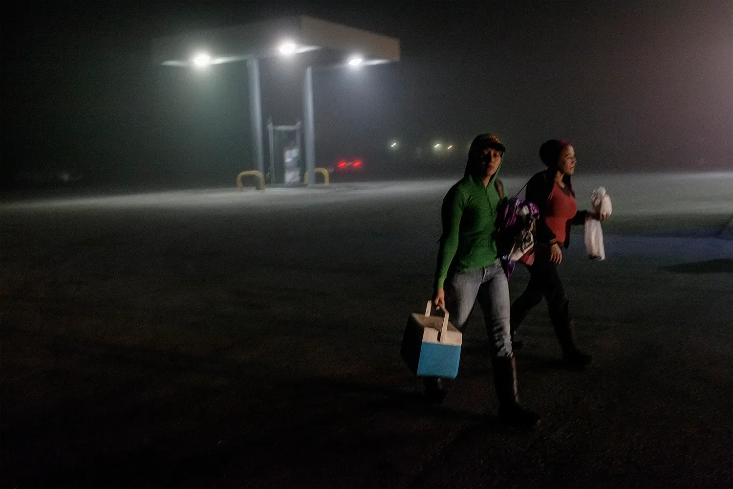 Farmworkers at 5am on their way to load the buses that transport them to the fields in Clewsiton.