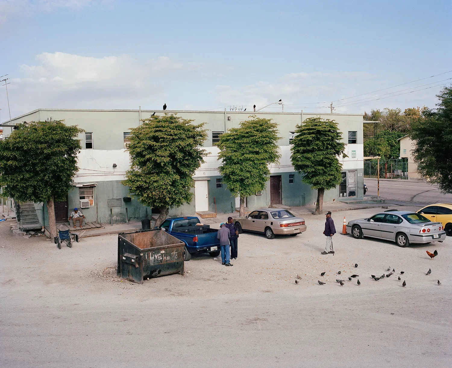 A remodeled rooming house apartment. The branches of the trees were cut every time there was a shooting to provide more visibility. This apartment complex was a gathering spot for several older Haitian residents.