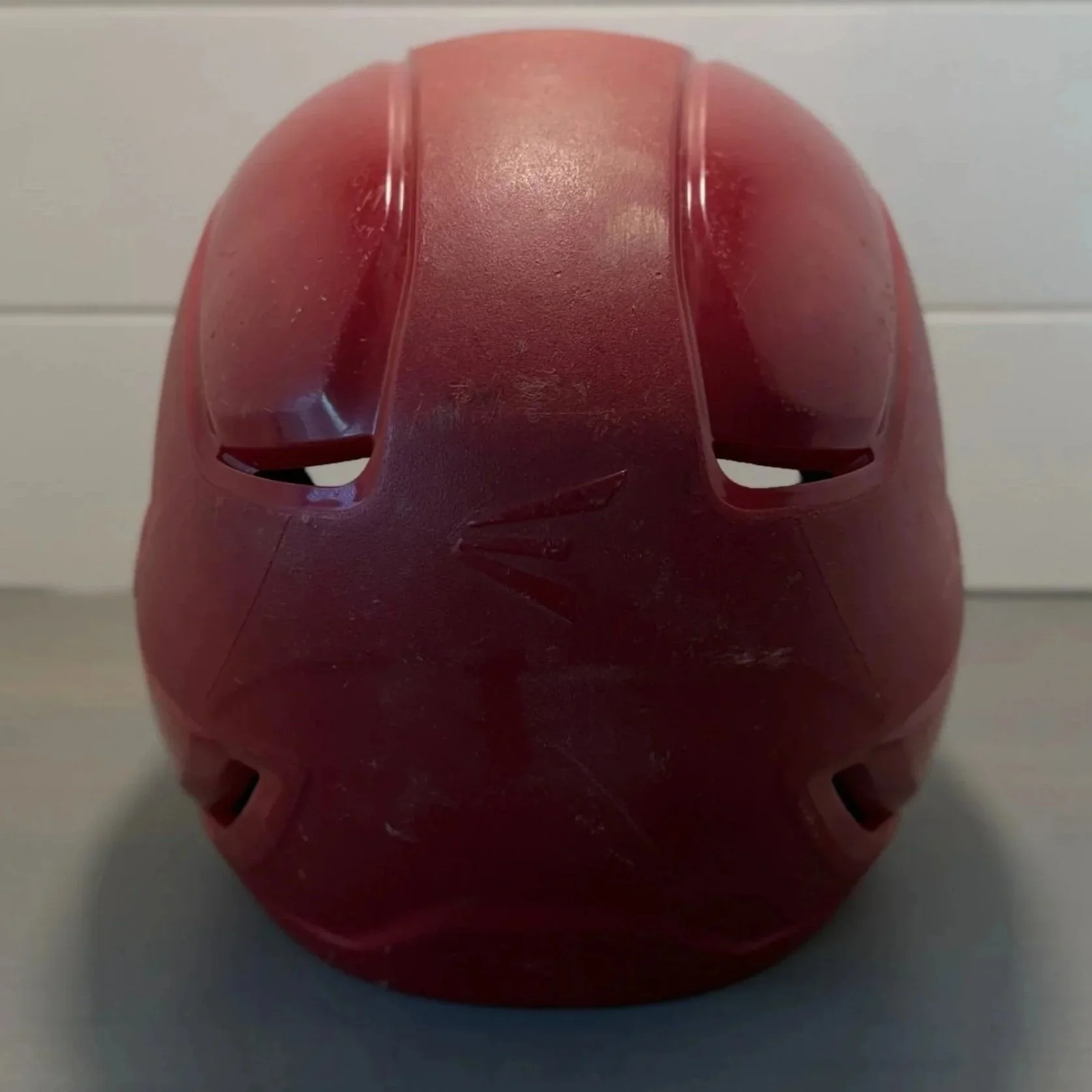 Close-up of a red basketball with black lines, viewed from a low angle against a white background.