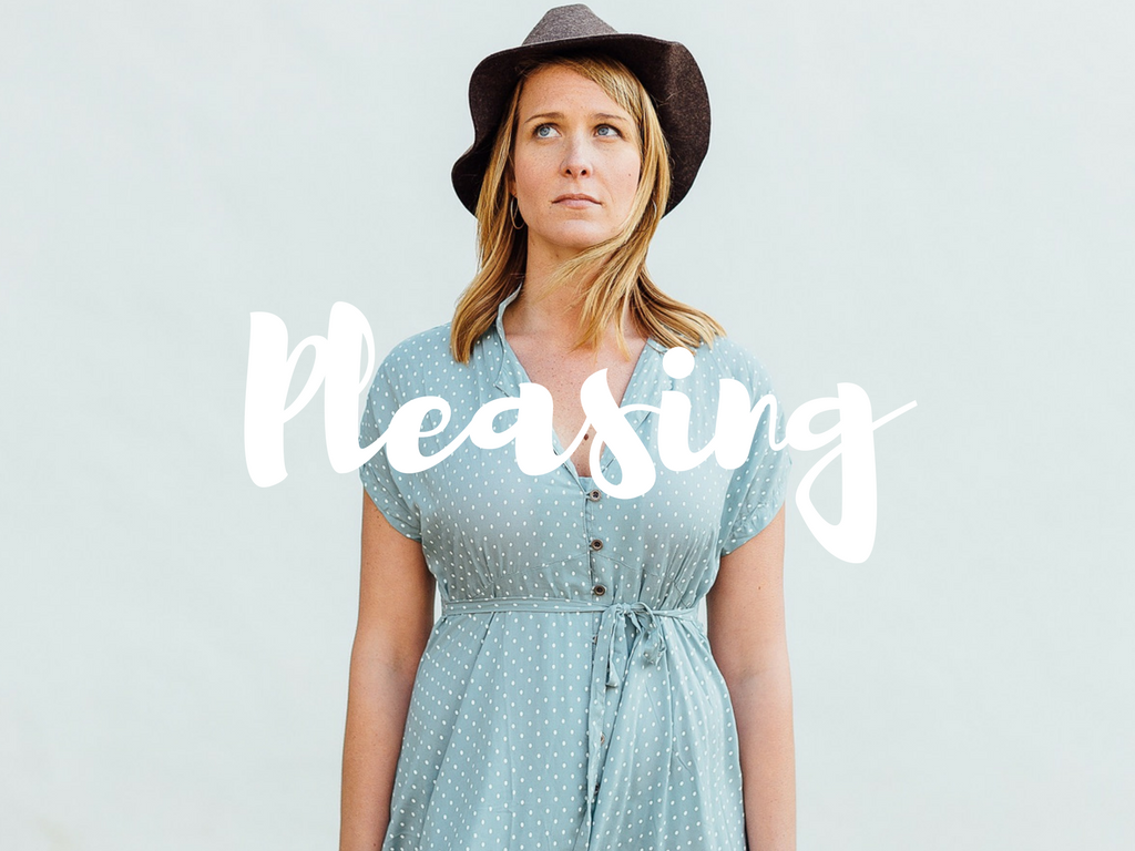 woman in hat looking up with the word pleasing from trauma therapist sacramento