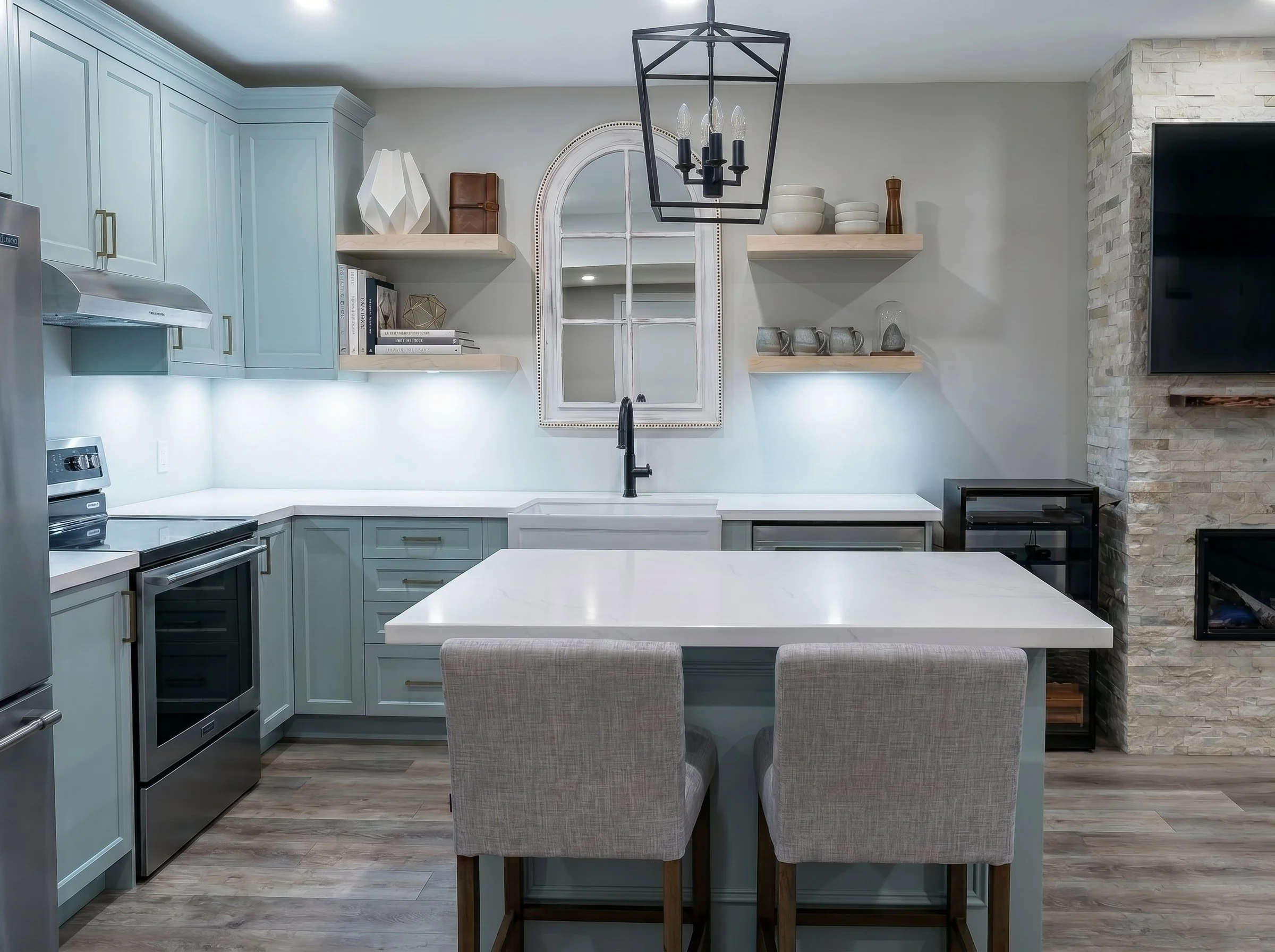 Custom basement kitchen with shaker cabinetry, quartz countertops and a spacious island.