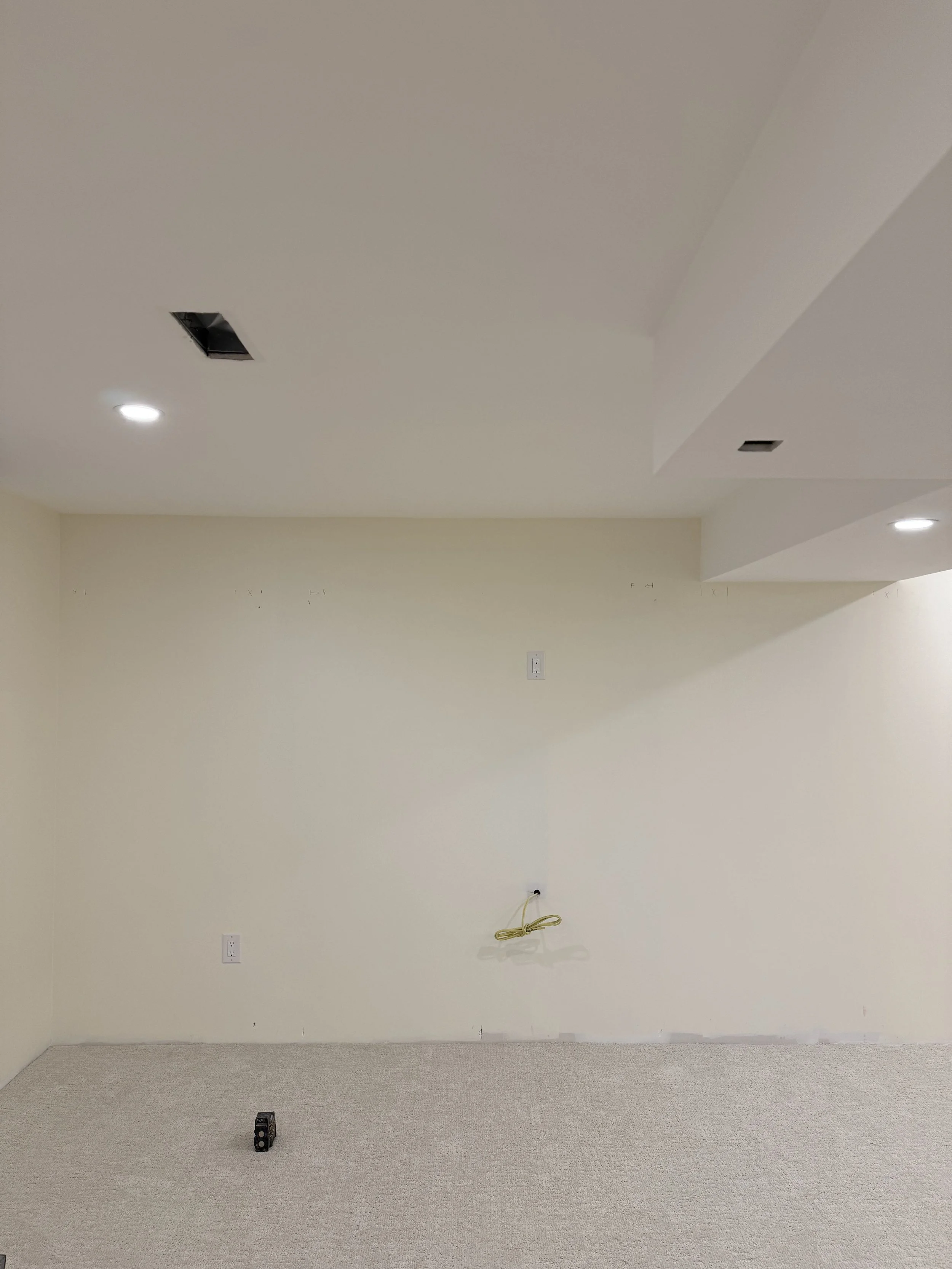 Newly finished drywall before installation of the custom fireplace feature.