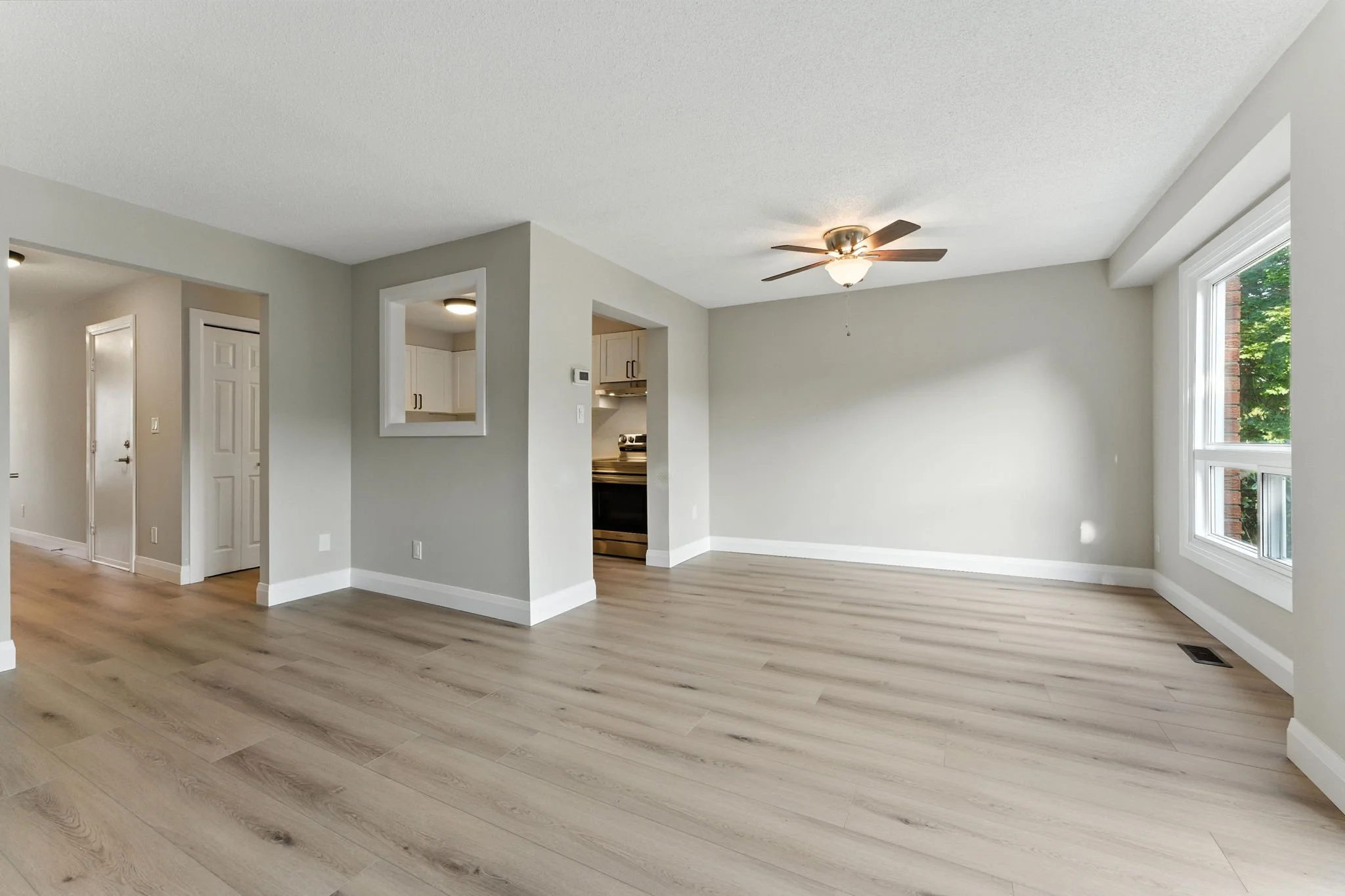 Open main floor after renovation with updated finishes and seamless flow between living spaces.