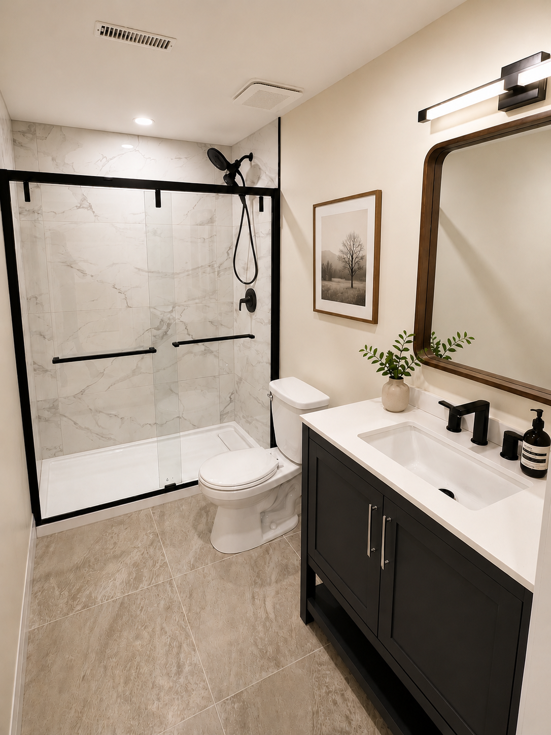 Modern basement bathroom featuring a custom vanity, glass shower and matte black fixtures.