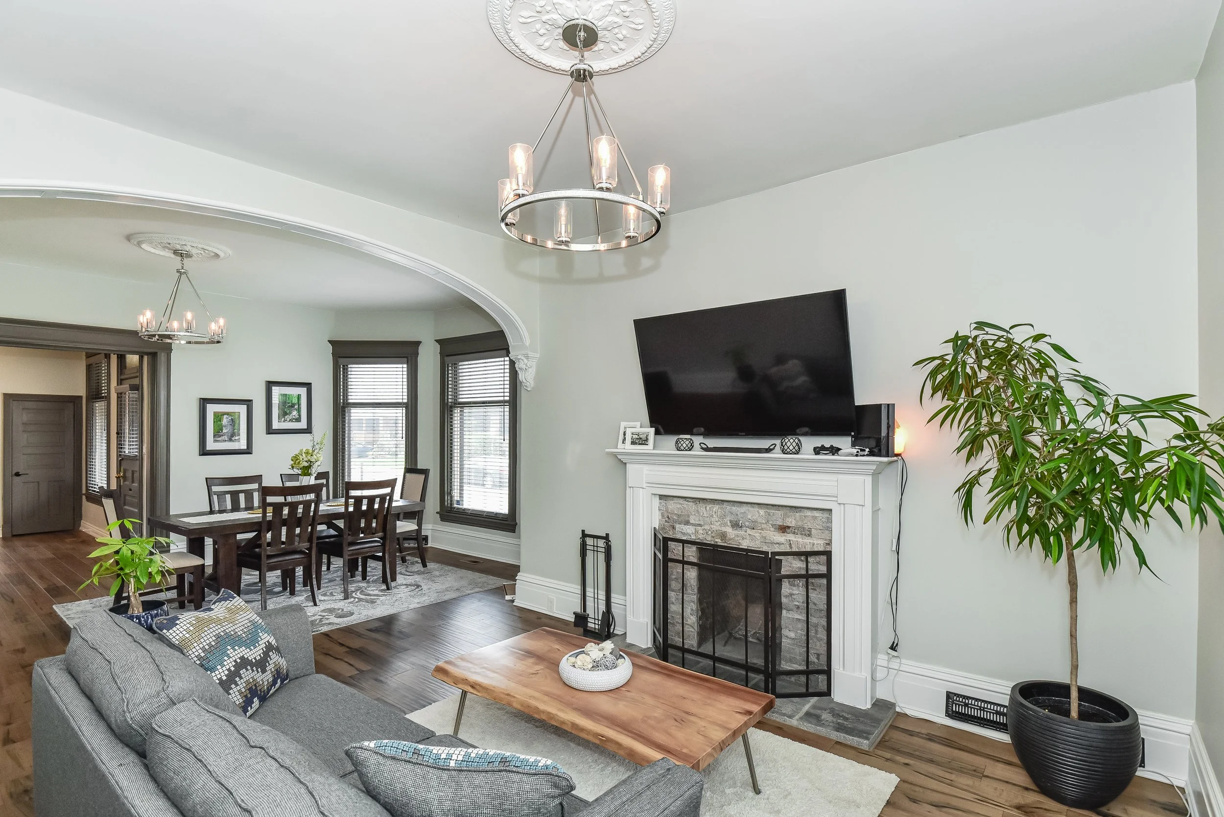 Inviting living room featuring a fireplace, custom finishes and abundant natural light