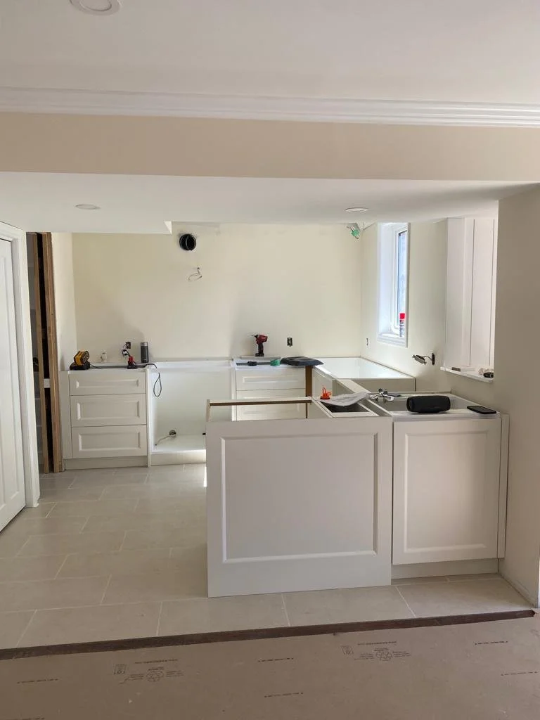 Basement kitchenette during construction and cabinet installation.