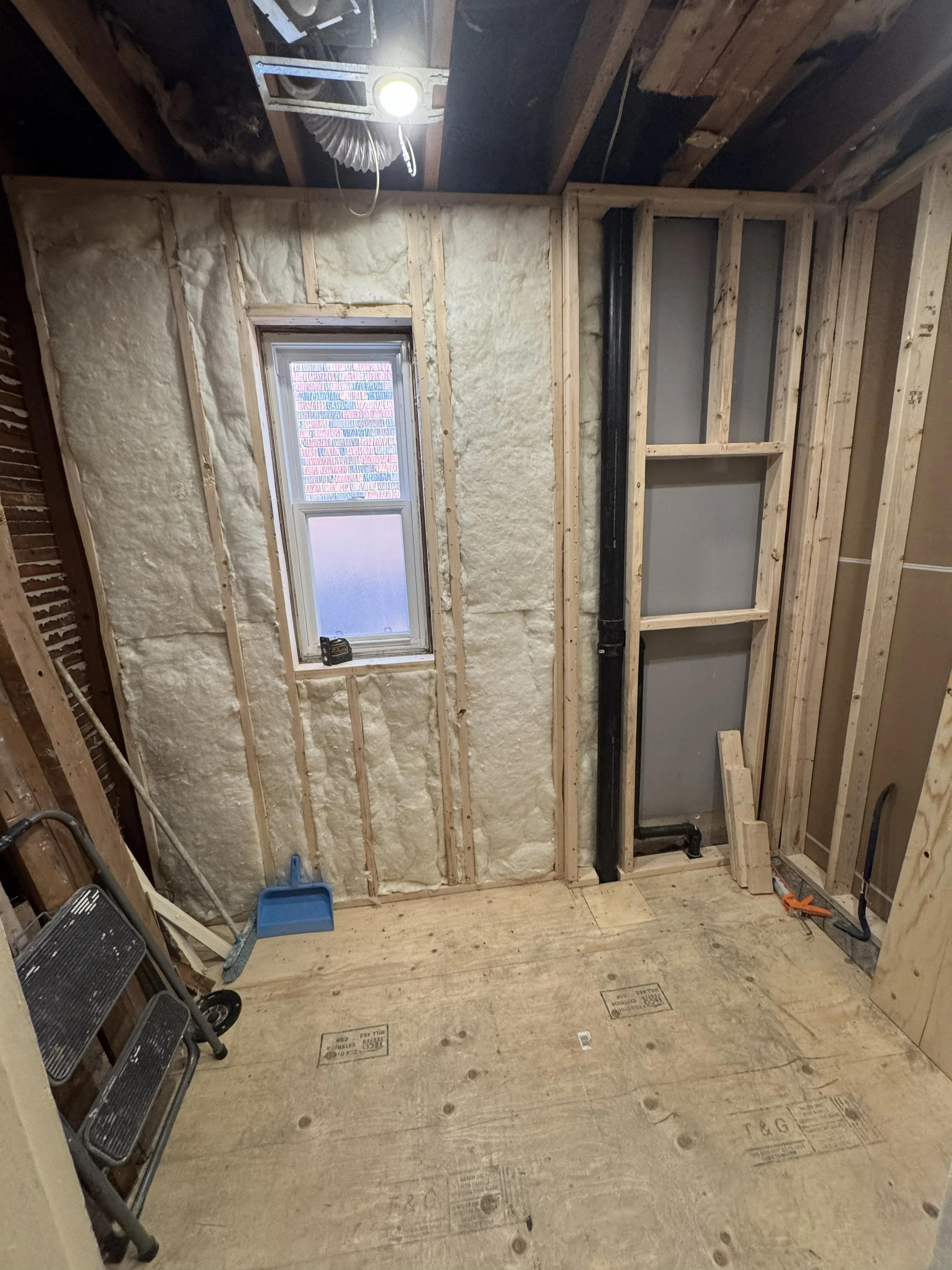 Bathroom framing prepared for plumbing, insulation and new finishes.