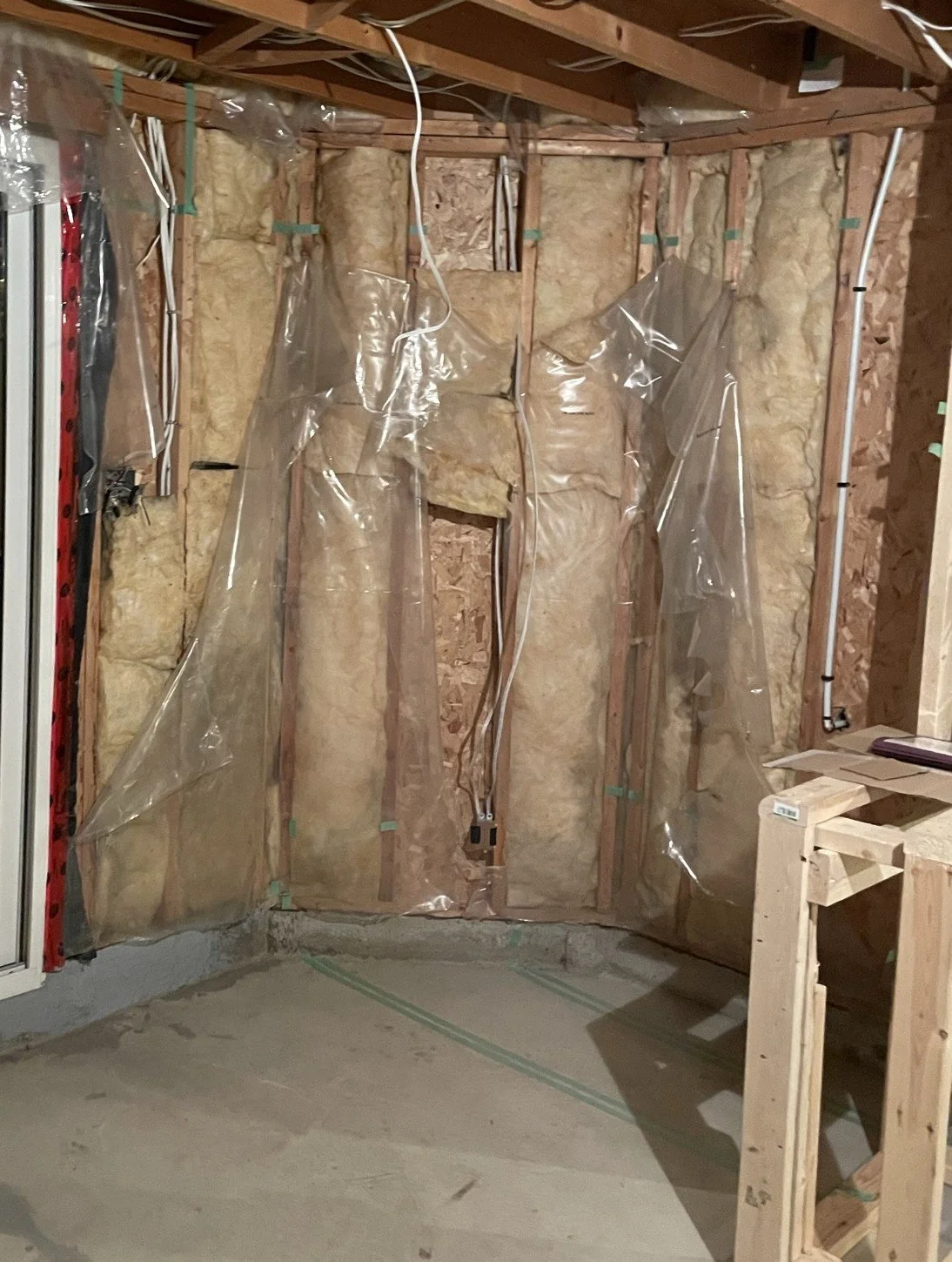 Original basement exterior wall before insulation and bench area finishing.