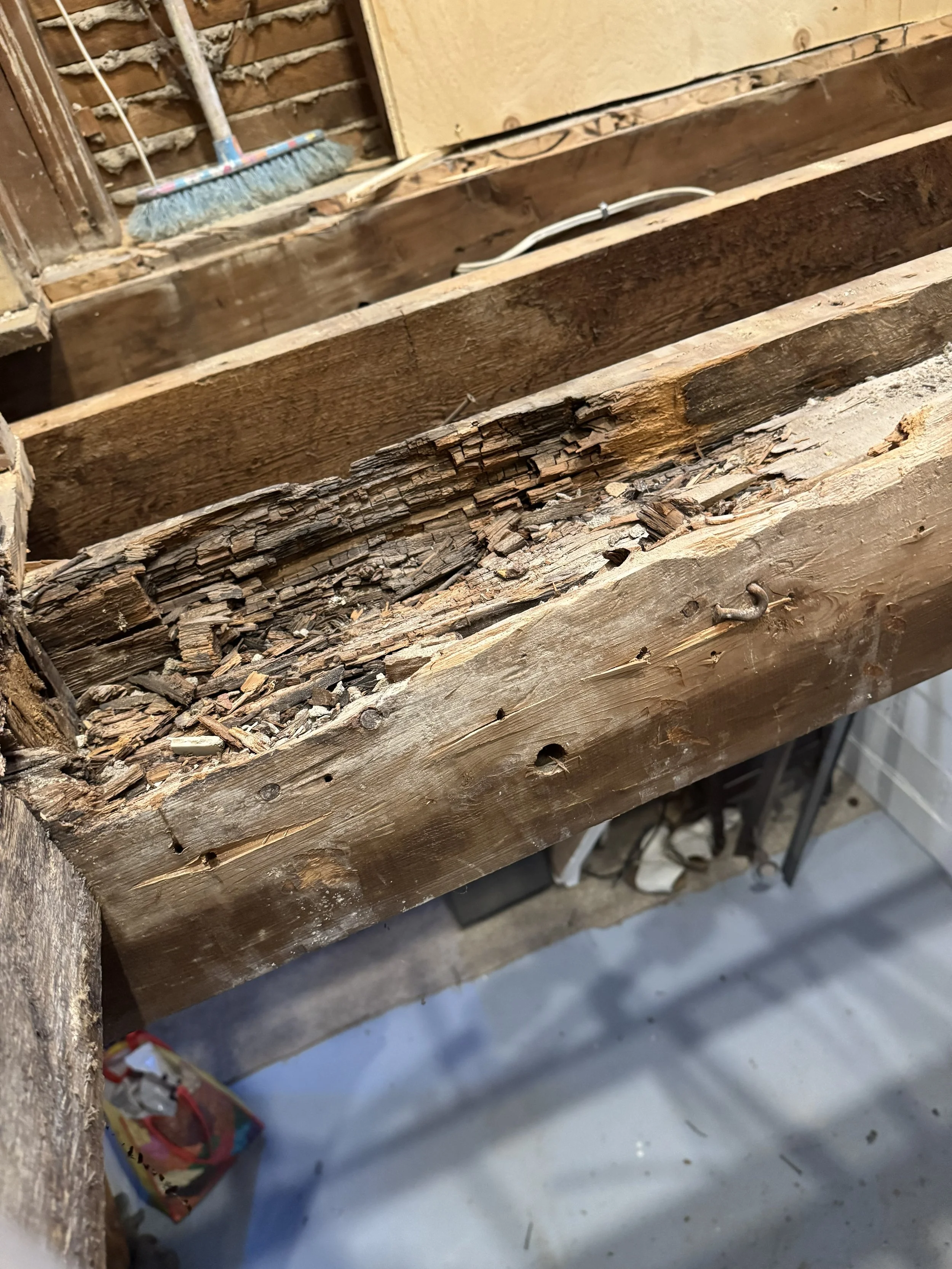 Water-damaged framing uncovered during bathroom demolition.