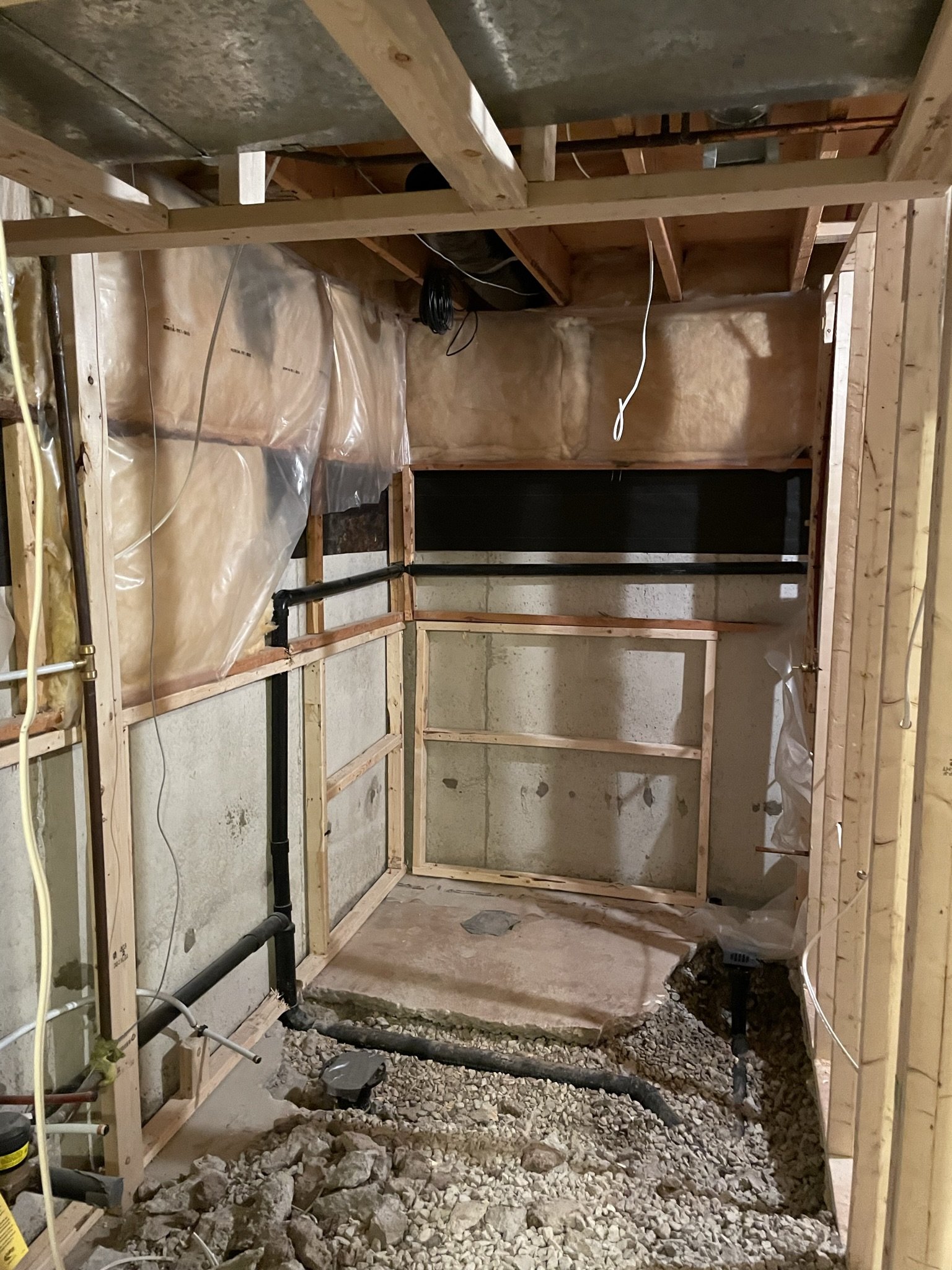 Unfinished basement bathroom before framing and construction began.