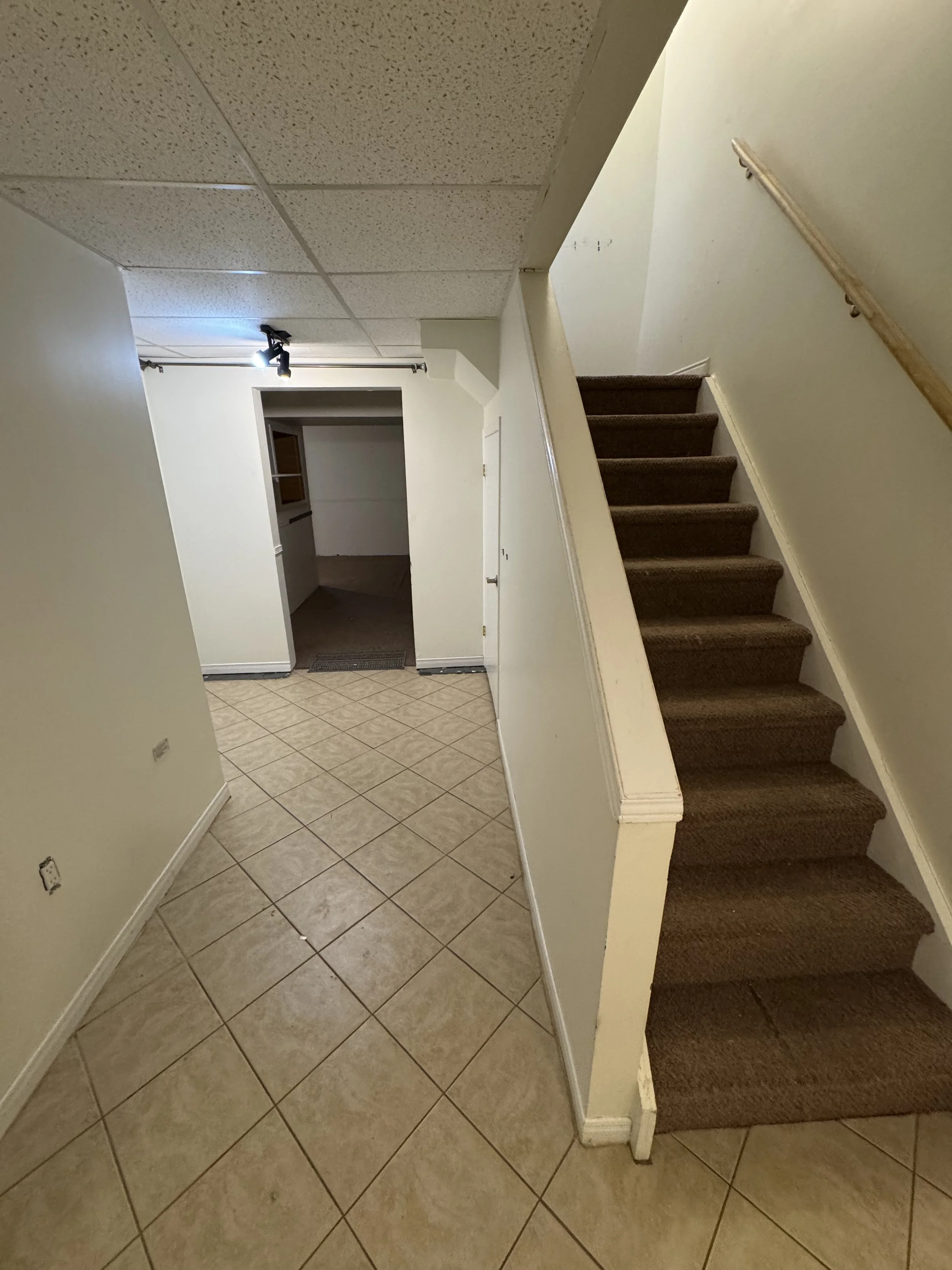 Existing staircase to basement before the renovation began.