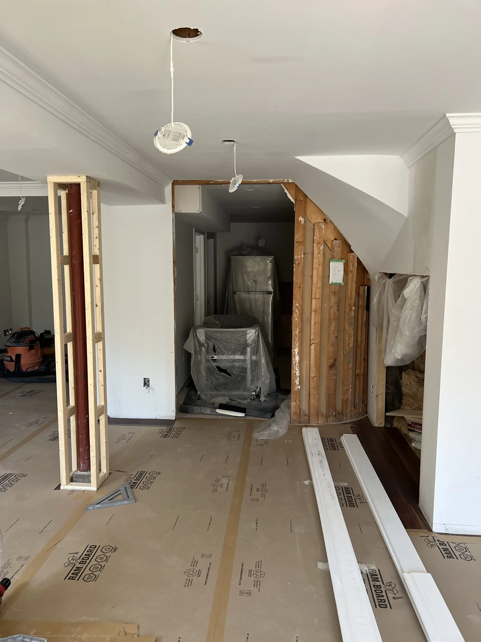 Basement framing underway before drywall and interior finishes.