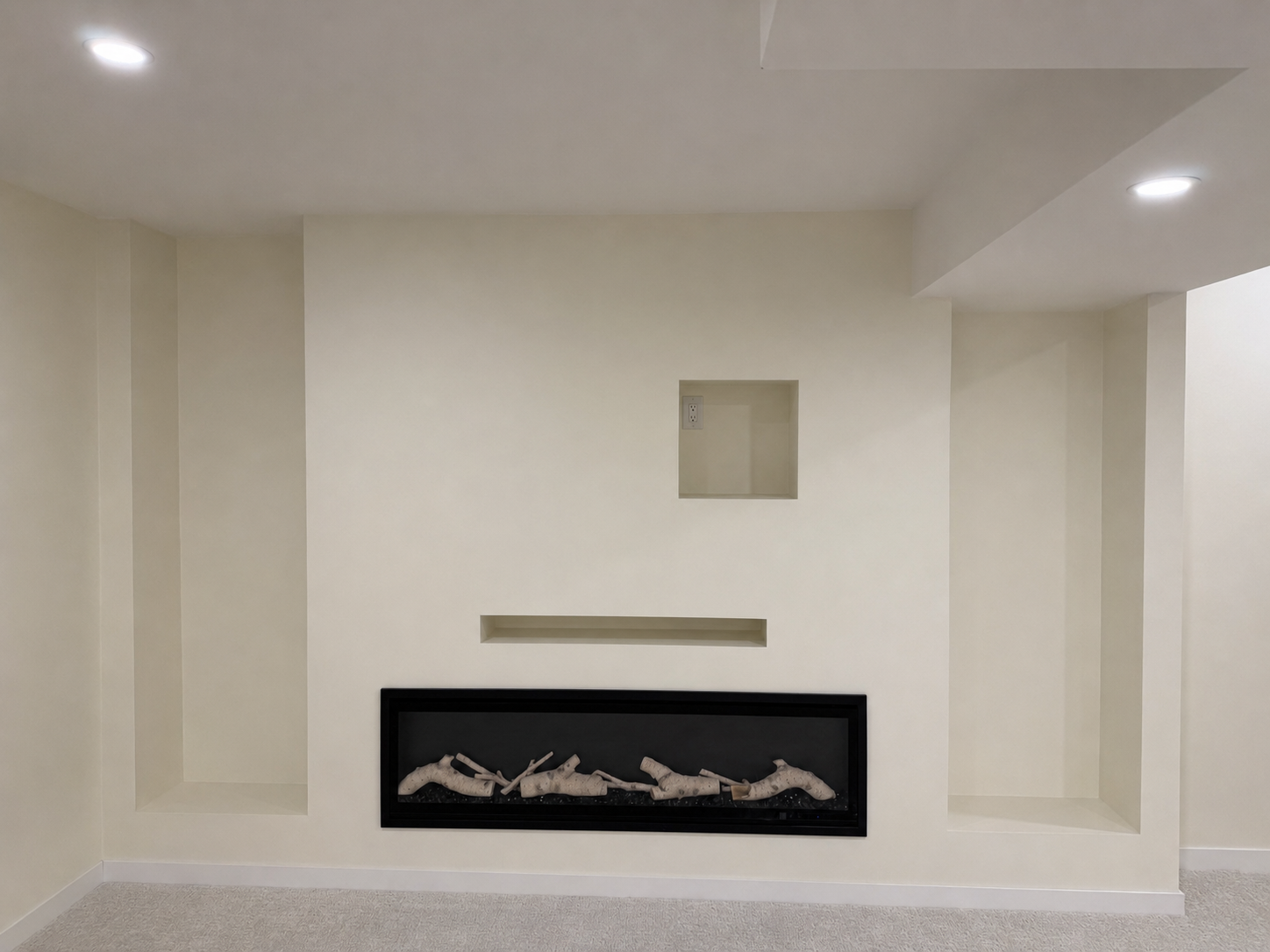 Custom fireplace feature wall drywalled and prepared for finishing.