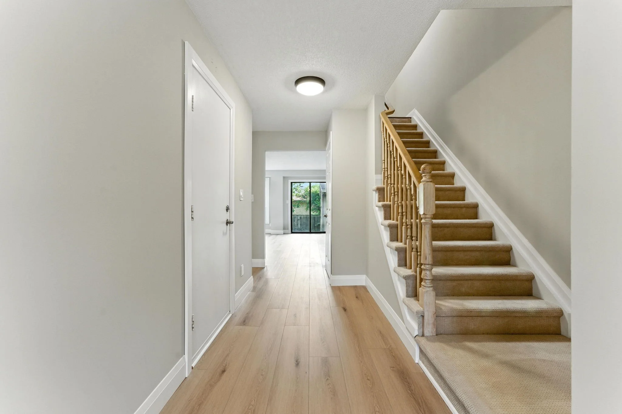 Renovated staircase and hallway with modern finishes and improved circulation.