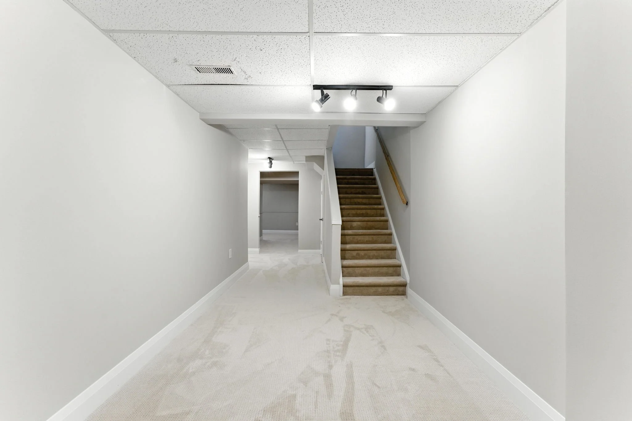 Finished basement with an open layout, recessed lighting and quality carpet flooring.