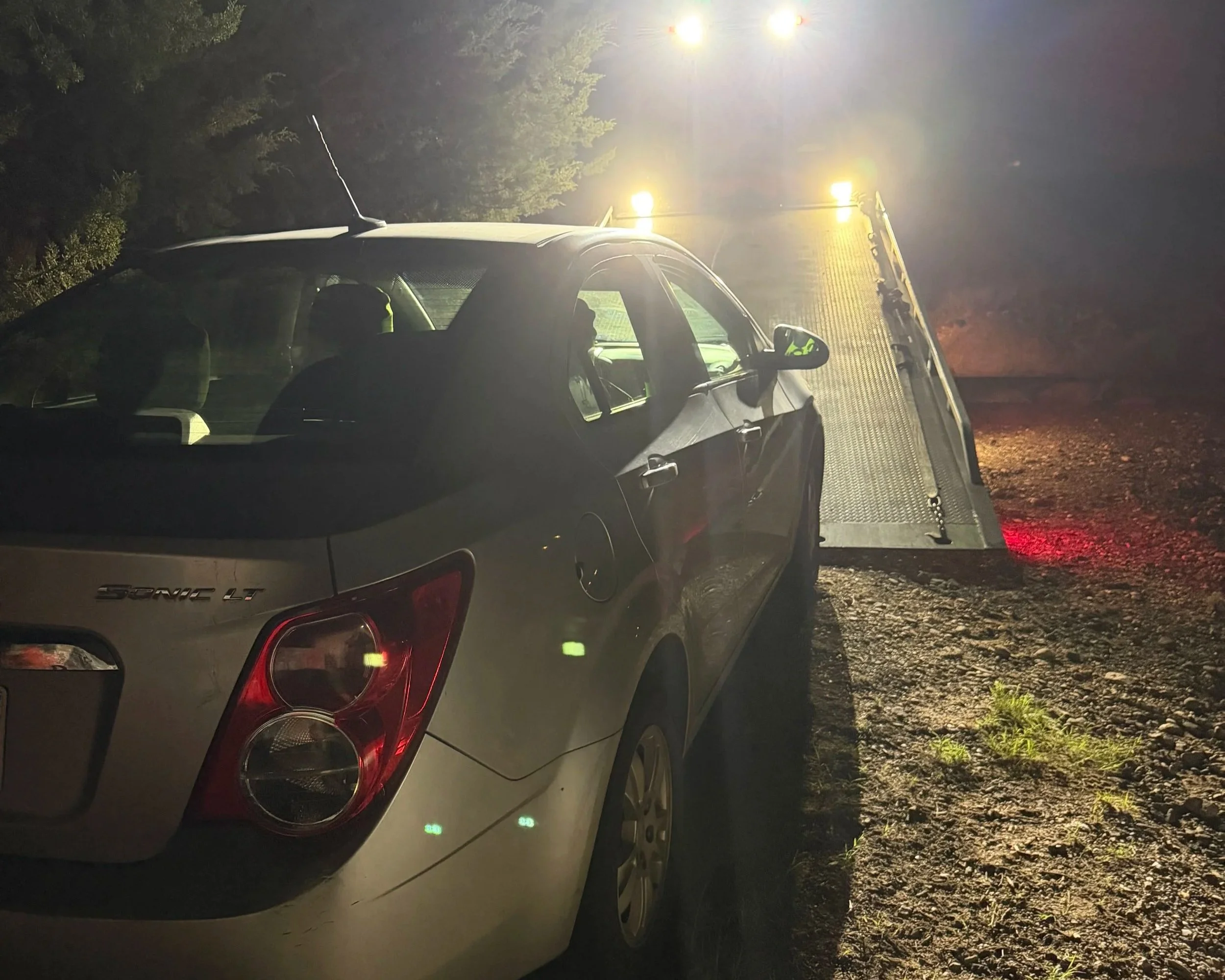 Vehicle getting secured for long-distance towing on a N&A Towing rollback