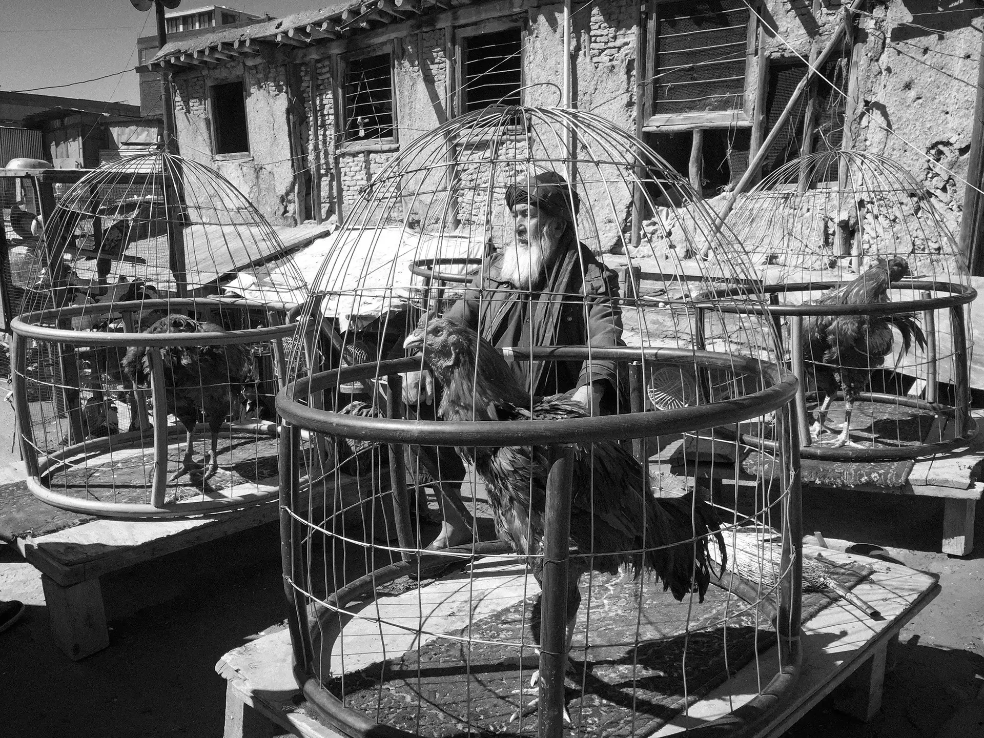 Black and white documentary photography featuring an outdoor marketplace structure,Kabul,  Afghanistan.