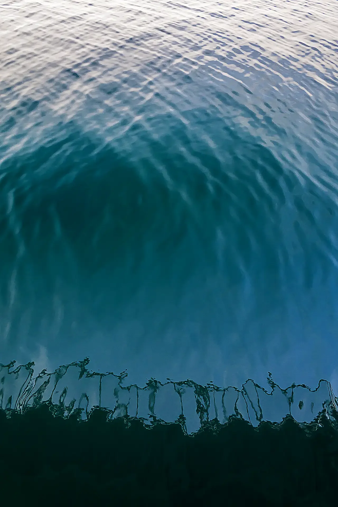 capturing a unique view of the Gulf of Oman, Iran, from within an oil tanker. Low-key lighting with deep blue textures.⁠