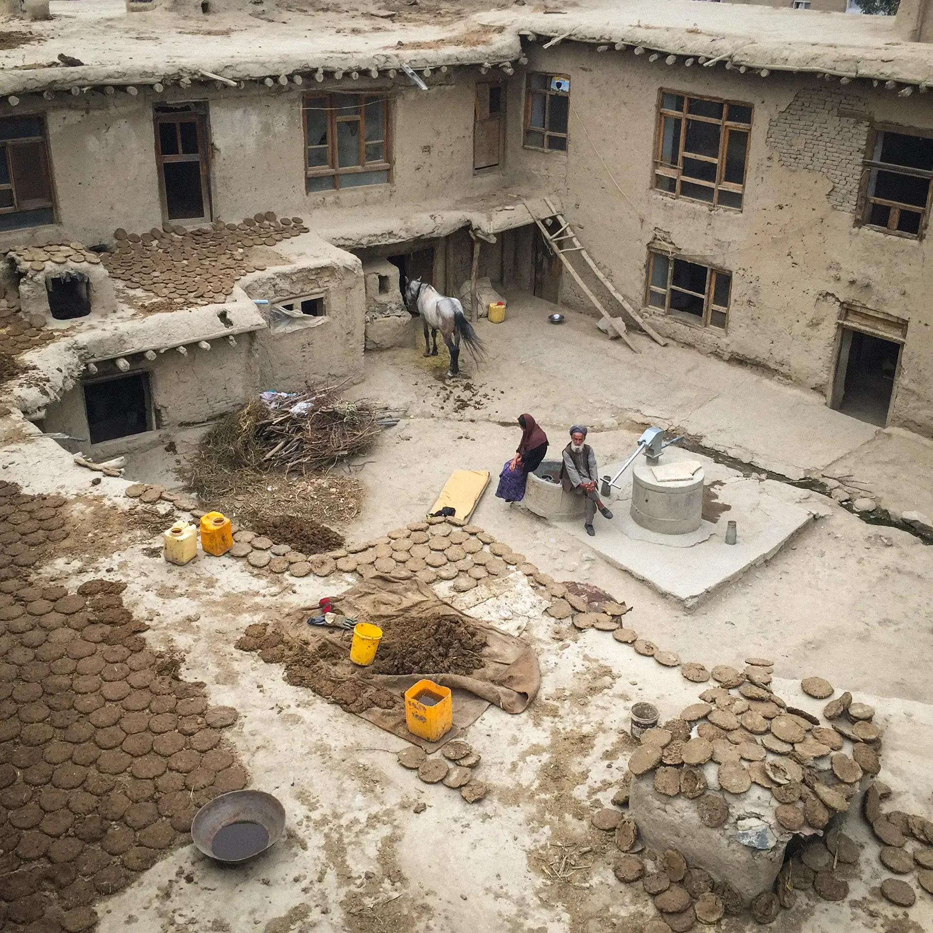 High-angle documentary photography showcasing a traditional courtyard settlement, Afghanistan.