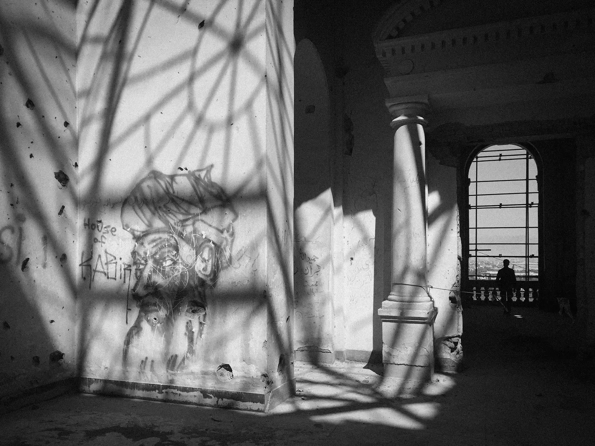 Fine art abstract documentary capturing high-contrast geometric light and shadows on a wall, Darulaman, Kabul, Afghanistan.