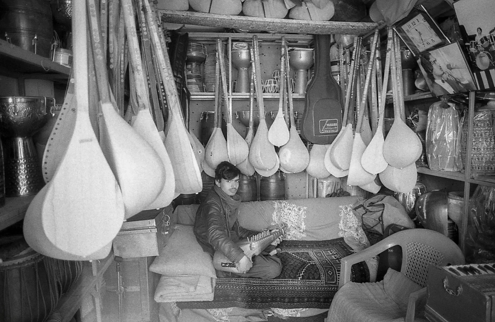 ⁠Documentary photography showcasing a traditional musical instrument workshop, Kouche Kharabat, Kabul, Afghanistan