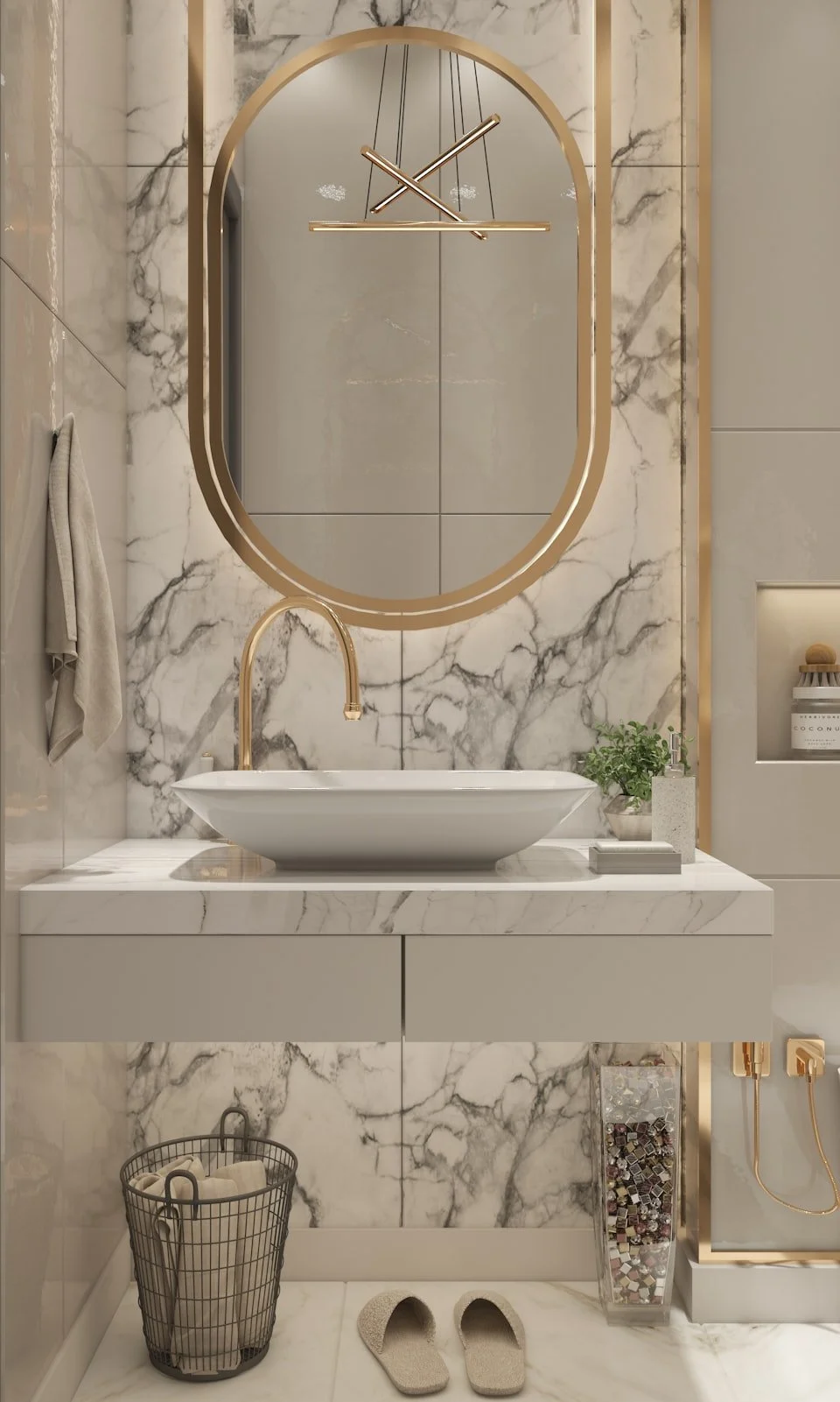 Modern bathroom with marble walls and countertop, oval mirror, wall clock, white vessel sink with gold faucet, potted plant, soap dispenser, storage box, beige slippers, laundry basket with towels, and decorative mosaic tiles.