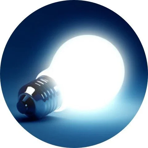 A glowing light bulb turned on in a dark environment.