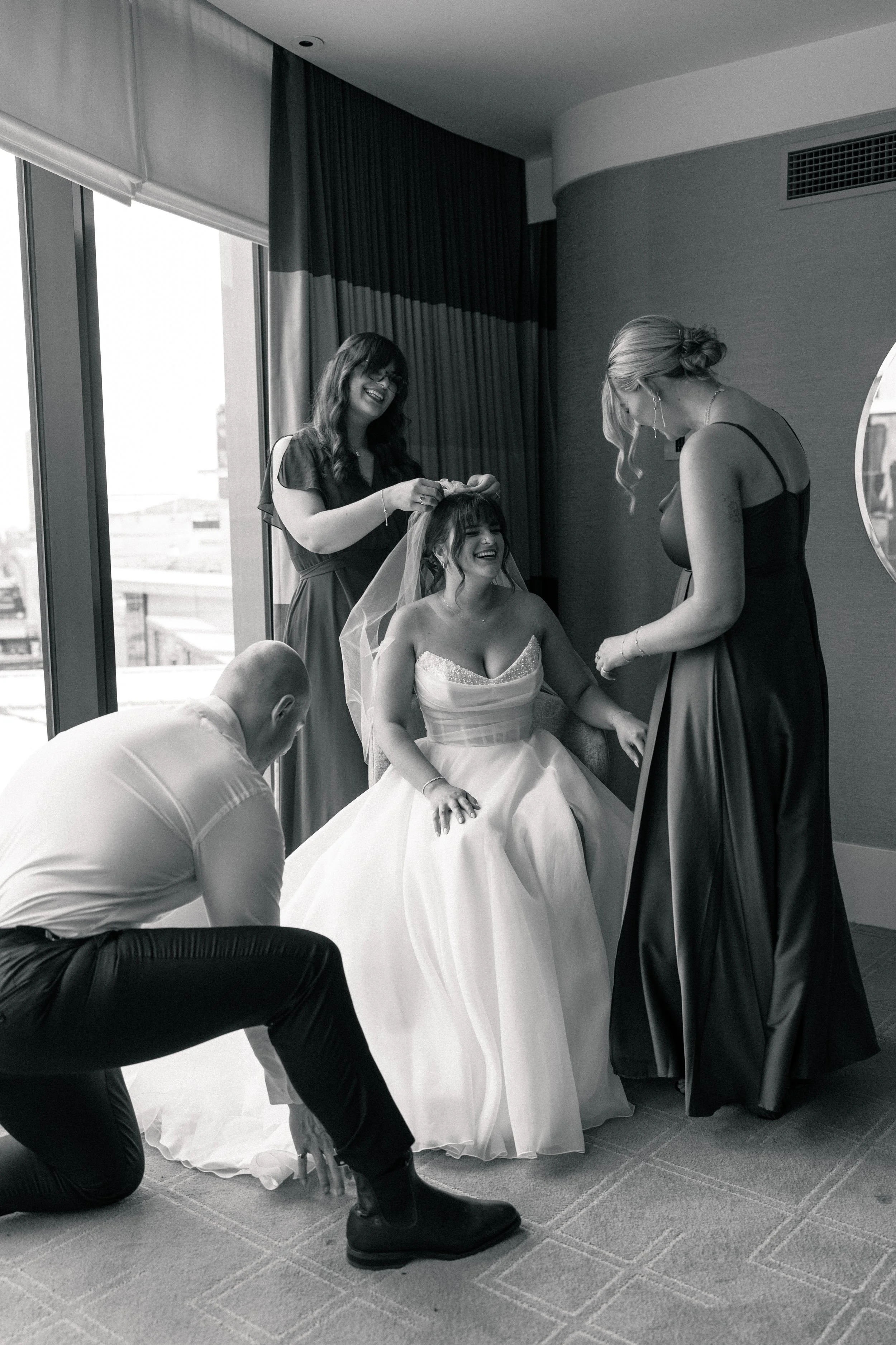 Bride getting ready with bridesmaids captured by a Melbourne wedding photographer